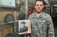 Staff Sgt. Joshua Conner holds a photograph of his relative 1st Lt. Garlin Murl Conner, World War II veteran. According to various news reports, G. Conner is the second most decorated soldier from World War II.
(U.S. Army photo by Spc. David Lietz/Released)