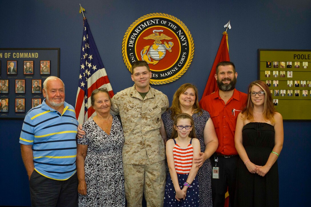 U.S. Marine Corps Corporal William Pawley poses with his family following his promotion to his present rank at a recruiting office in Newark, Delaware, August 3, 2015. Pawley, a native of Wilmington, Delaware, and a 2011 graduate of Delcastle High School recently returned from a seven-month deployment to the Mediterranean Sea, where he served as an airframes mechanic aboard the USS Iwo Jima. (U.S. Marine Corps photo by Sgt. Bryan Nygaard/Released)