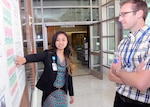 Betty Nguyen (left), a student at the University of California, Los Angeles, explains her poster to Graham Poagge, a biological science technicion at Brooke Army Medical Center clinical studies Aug. 12.