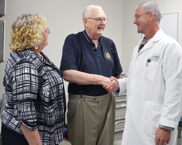 Army Col. (Dr.) Douglas Soderdahl, BAMC’s deputy commander for acute care, checks in with his longtime patient, Frank Samas, while Janet Schadee, urology and oncology clinical nurse, looks on in the Urology Department at San Antonio Military Medical Center Aug. 11. 