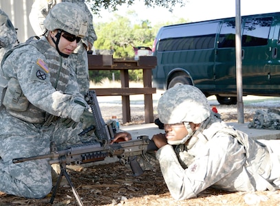 Sgt. Jimmy Martinez (left) explains the proper procedure for cleaning a weapon to SpSpc. Marcus Holmes (right) at Camp Bullis Aug. 25. Both Soldiers are assigned to U.S. Army South’s Intelligence and Sustainment Company.