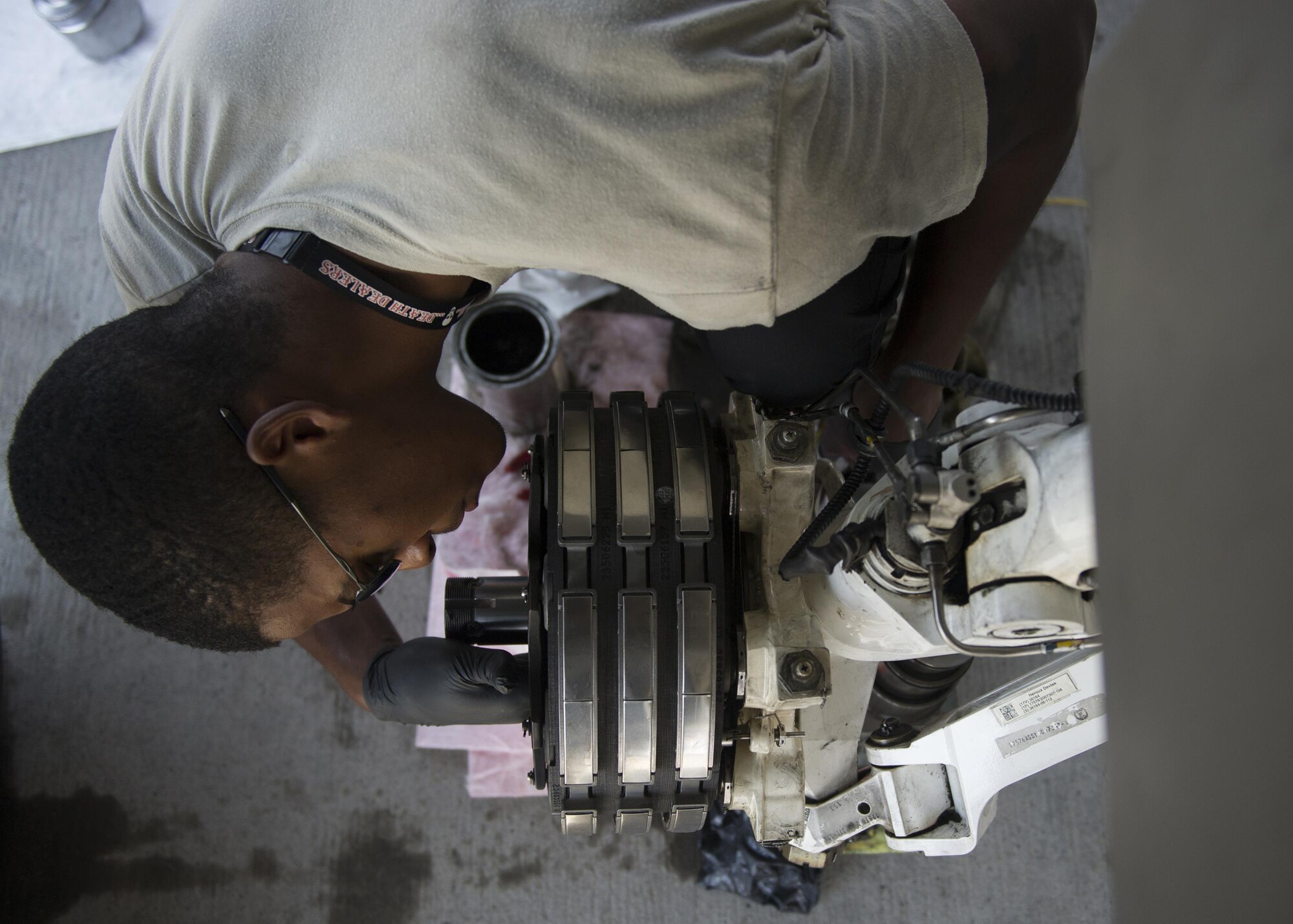 Senior Airman Jordan Cotton, a 77th Aircraft Maintenance Squadron maintainer out of Shaw Air Force Base, S.C., greases an F-16  landing gear before putting the tire into place during a Red Flag exercise Thursday, Aug. 20, 2015 at Nellis Air Force Base, Nev. NASIC provides real-time documentation to help train both U.S. and allied nations’combat air forces. The exercise gives pilots the experience of multiple, intensive air combat sorties in the safety of a training environment. (U.S. Air Force photo by Senior Airman Justyn Freeman)