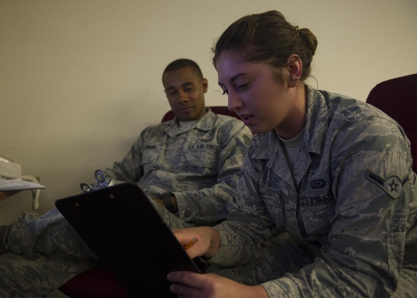 Staff Sgt. Jamaal (left) and Airman Keirstin, members of the National Air and Space Intelligence Center, discusses the tallied hits from pre-1980’s surface to air missile systems during a Red Flag exercise exercise Thursday, Aug. 20, 2015 at Nellis Air Force Base, Nev. NASIC provides real-time documentation to help train both U.S. and allied nations’combat air forces. The exercise gives pilots the experience of multiple, intensive air combat sorties in the safety of a training environment. (U.S. Air Force photo illustration by Senior Airman Justyn Freeman)