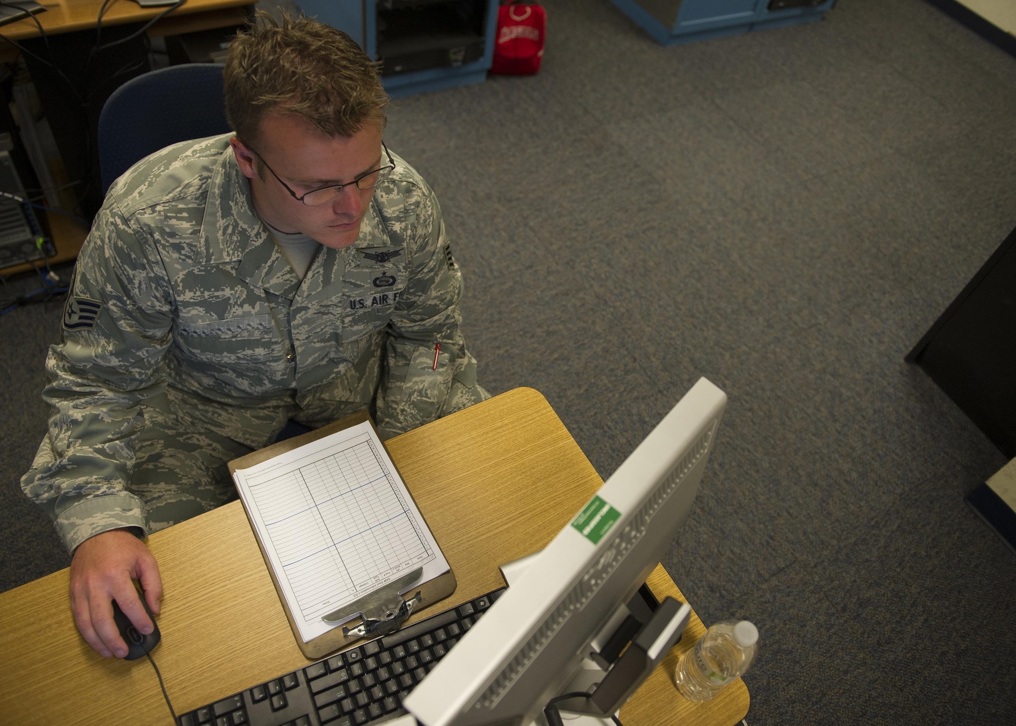 Staff Sgt. Tyler, a member of the National Air and Space Intelligence Center, watches aircraft movement during a Red Flag exercise Thursday, Aug. 20, 2015 at Nellis Air Force Base, Nev. NASIC provides real-time documentation to help train both U.S. and allied nations’combat air forces. The exercise gives pilots the experience of multiple, intensive air combat sorties in the safety of a training environment. (U.S. Air Force photo illustration by Senior Airman Justyn Freeman)
