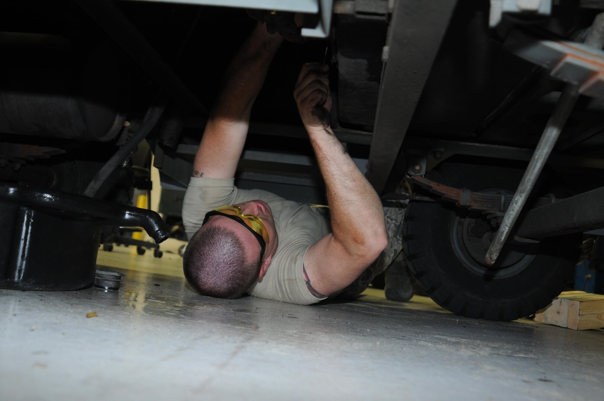 Senior Airman Adam Srock, an aerospace ground equipment mechanic for the 910th Maintenance Squadron, works on removing an 86 generator from its car here, July 31, 2015. (U.S. Air Force photo/Tech. Sgt. Rick Lisum)
