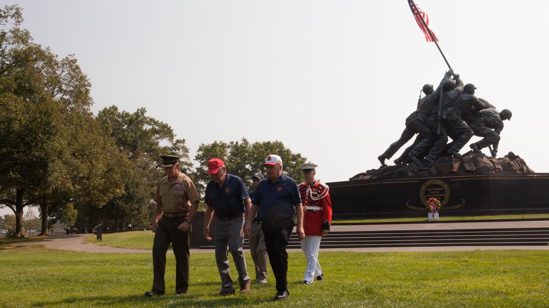 Members of Company “H”, 2nd Battalion, 26th Marines and Rear Adm. Brent W. Scott, the Chaplain of the United States Marine Corps, return from laying a wreath during a Remembrance Ceremony held at the Marine Corps War Memorial at Arlington, Va., Sept. 3. The wreath was laid in honor of the 74 Marines and sailors who did not come home.
