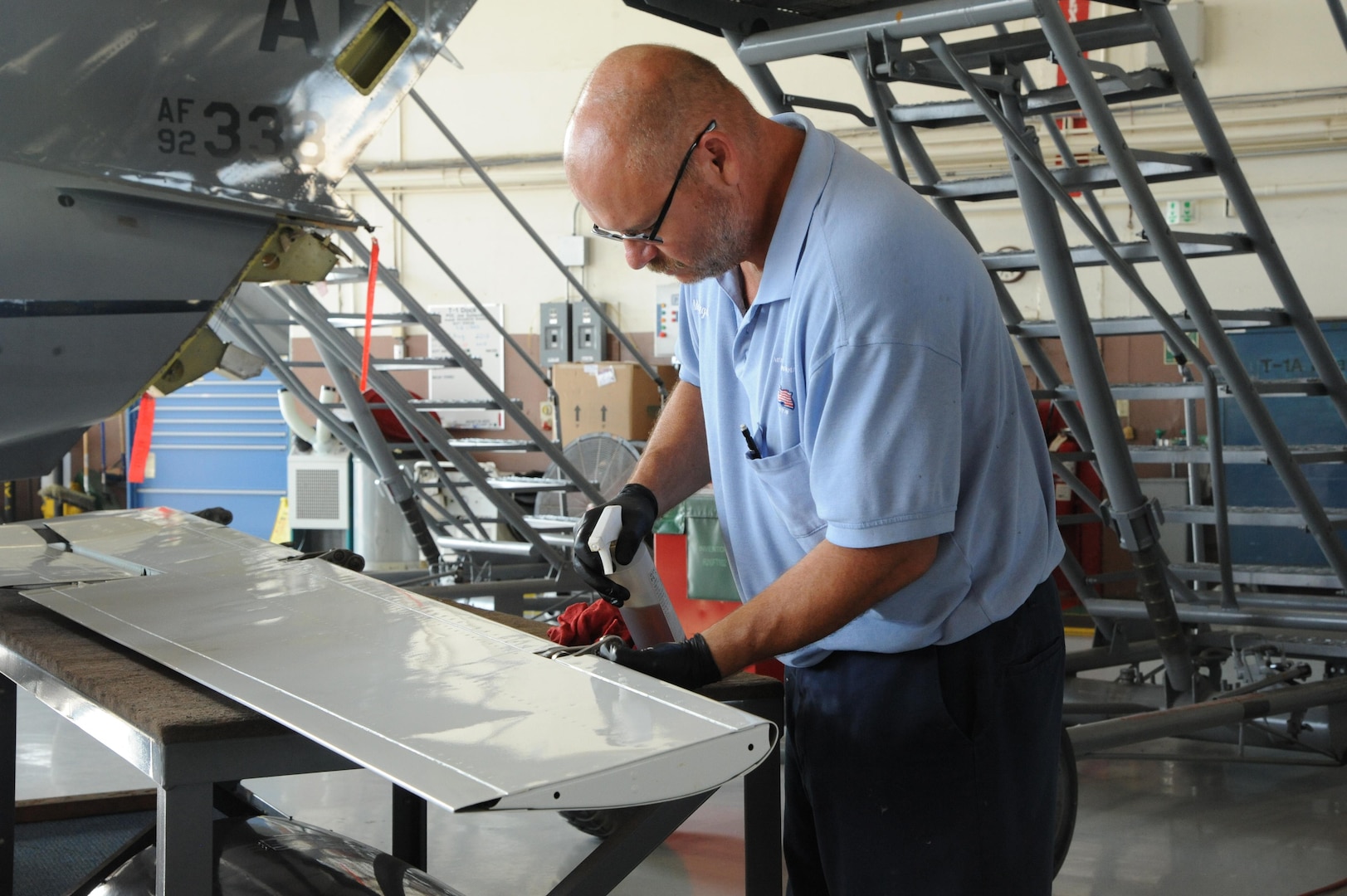 Kris McGurgan, 12th Flying Training Wing maintenance technician, inspects and cleans a trailing edge flap on a T-1 Jayhawk during the aircraft's phase maintenance inspection Aug. 17, 2015 at Joint Base San Antonio-Randolph.   To ensure aircraft remain operational, 12th FTW maintenance personnel conduct phase maintenance to make sure the aircraft is in working order.  