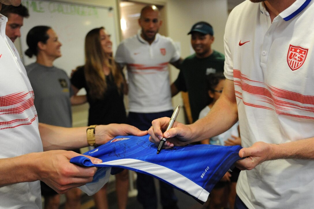 U.S. men's national soccer team members autograph soccer jerseys for wounded warrior at Walter Reed National Medical Center in Bethesda, Md., Sept. 3, 2015. DoD photo by Marvin Lynchard