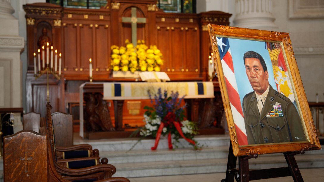 A display for Lt. Gen. Frank E. Petersen, Jr. (ret.) is showcased during his memorial service at the U.S. Naval Academy in Annapolis, Md., Sept. 3, 2015. Petersen died Aug. 25, 2015, after succumbing to lung cancer. Petersen was the first African-American Marine Corps aviator and general officer. 