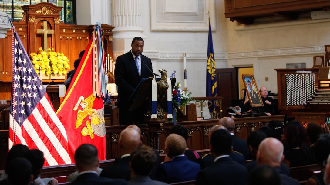 Frank E. Petersen III speaks about his father during a memorial service at the U.S. Naval Academy in Annapolis, Md., Sept. 3, 2015. Lt. Gen. Frank E. Petersen, Jr. (ret.), died Aug. 25, 2015, after succumbing to lung cancer. During his career, Petersen flew more than 350 combat missions and more than 4,000 hours in various military aircraft. 