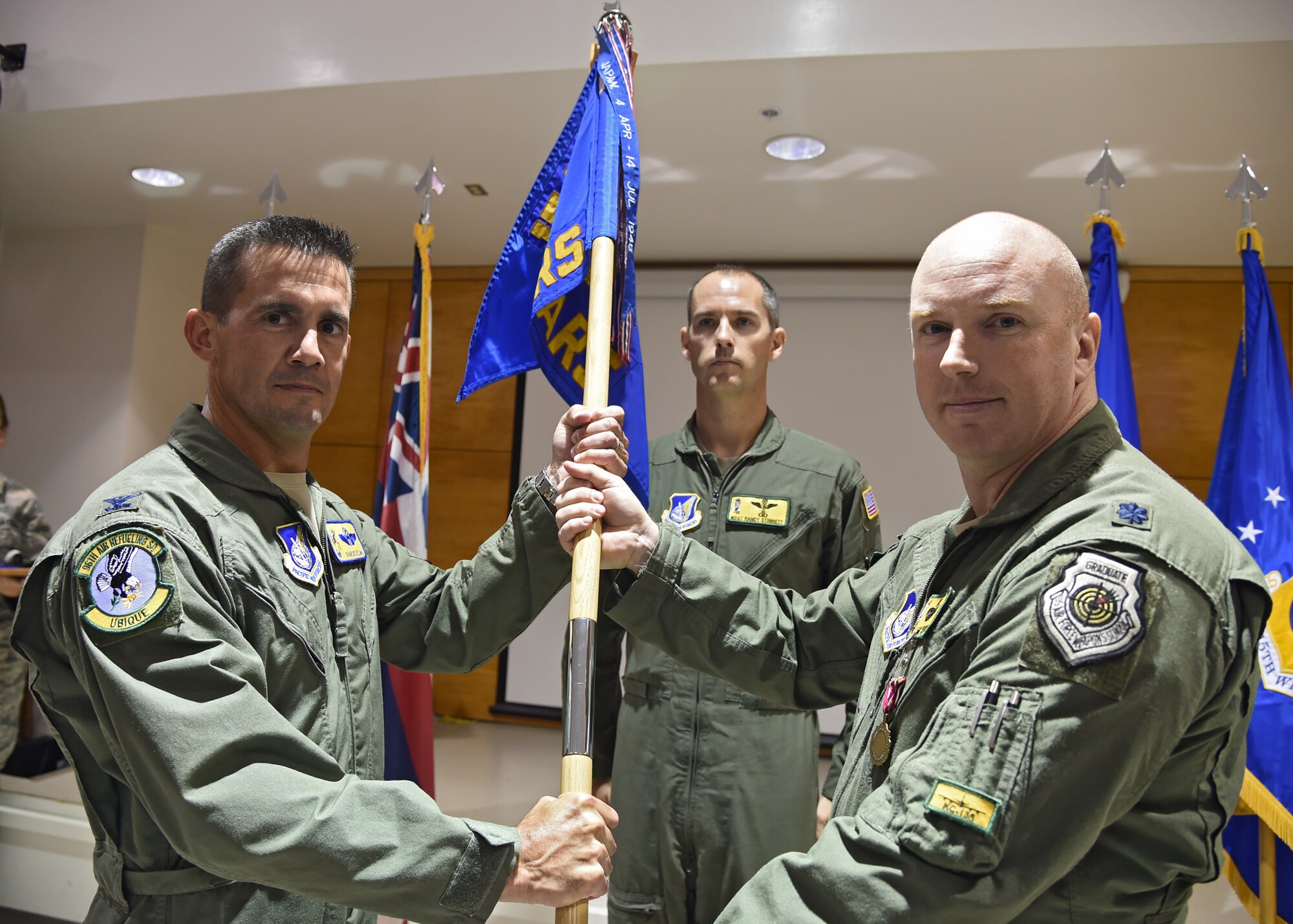 Col. Charles Velino, 15th Operations Group commander, receives the guidon as Lt. Col. Jason Work, 96th Air Refueling Squadron commander, relinquishes command during the 96th ARS deactivation ceremony on Joint Base Pearl Harbor-Hickam, Hawaii, Sept. 3, 2015. The 96th Air Refueling Squadron was reactivated on July 23, 2010, at Joint Base Pearl Harbor Hickam, in response to an increased demand for in-flight air refueling support throughout the Pacific theater. Since its reactivation, the 96th Air Refueling Squadron flew more than 1,800 sorties, totaling over 6,500 hours and offloading more than 36-million pounds of fuel to thousands of joint and multinational aircraft. (U.S. Air Force photo by Tech. Sgt. Aaron Oelrich/Released)