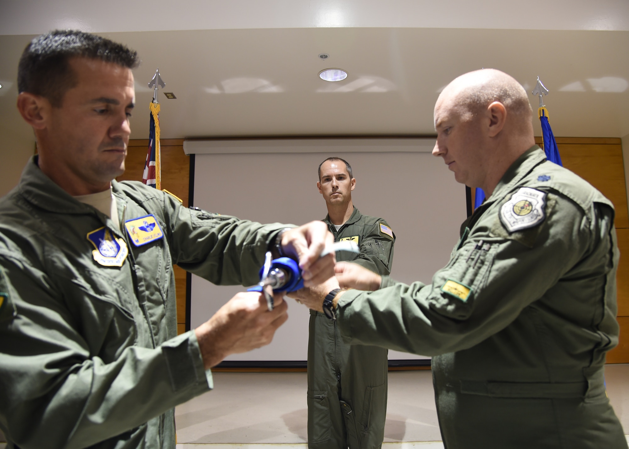 Col. Charles Velino, 15th Operations Group commander, and Lt. Col. Jason Work, 96th Air Refueling Squadron commander, secure the 96th ARS flag as Master Sgt. Randy Stinnett, 96th ARS superintendent, holds the guidon during the 96th ARS deactivation ceremony on Joint Base Pearl Harbor-Hickam, Hawaii, Sept. 3, 2015. The 96th Air Refueling Squadron was reactivated on July 23, 2010, at Joint Base Pearl Harbor Hickam, in response to an increased demand for in-flight air refueling support throughout the Pacific theater. Since its reactivation, the 96th Air Refueling Squadron flew more than 1,800 sorties, totaling over 6,500 hours and offloading more than 36-million pounds of fuel to thousands of joint and multinational aircraft. (U.S. Air Force photo by Tech. Sgt. Aaron Oelrich/Released)