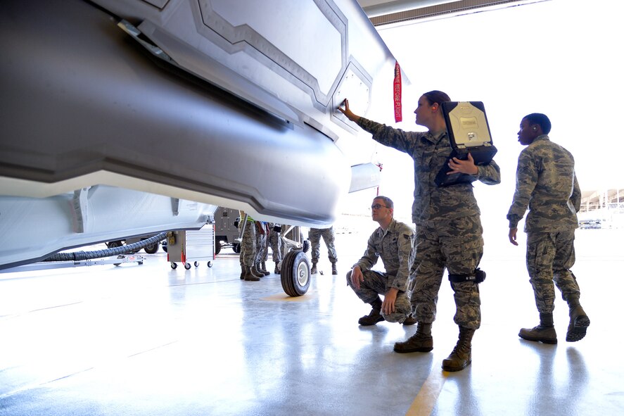 Senior Airman Samantha Callaway, an Air Force reservist in the 419th Aircraft Maintenance Squadron, performs a routine inspection on an F-35A’s internal weapons bay with her counterparts at Hill Air Force Base Sept. 3. Hill received the Air Force’s first operational F-35s Sept. 2, and maintenance personnel in the 419th Fighter Wing are already hard at work, getting hands-on training to become experts in fifth-generation technology. When fully trained, Callaway will be part of the 419th FW’s first certified weapons crew and will help train other Airmen in F-35 maintenance. (U.S. Air Force photo/R. Nial Bradshaw)