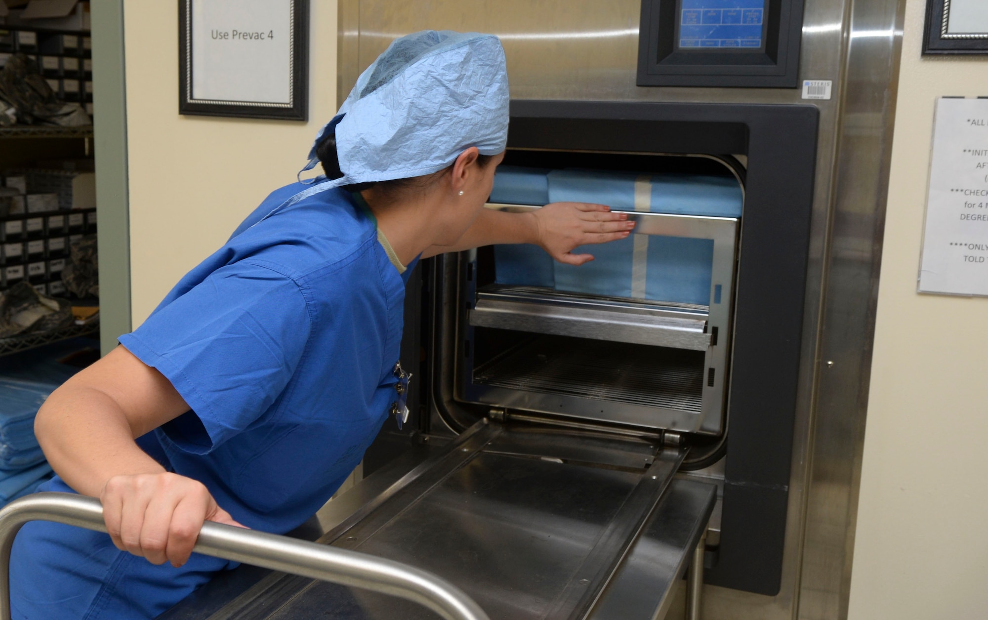 Staff Sgt. Tiffany Peeples, 2nd Dental Squadron dental technician, loads wrapped medical instruments into a sterilization machine at Barksdale Air Force Base, La., Sept. 1, 2015. The sterilization machine vacuums out air from all of the wraps and the water penetrates each wrap, beginning sterilization. During the 45-minute process, the machine reaches 270 degrees for four minutes to ensure the instruments have been sterilized correctly. (U.S. Air Force photo/Senior Airman Amanda Morris)