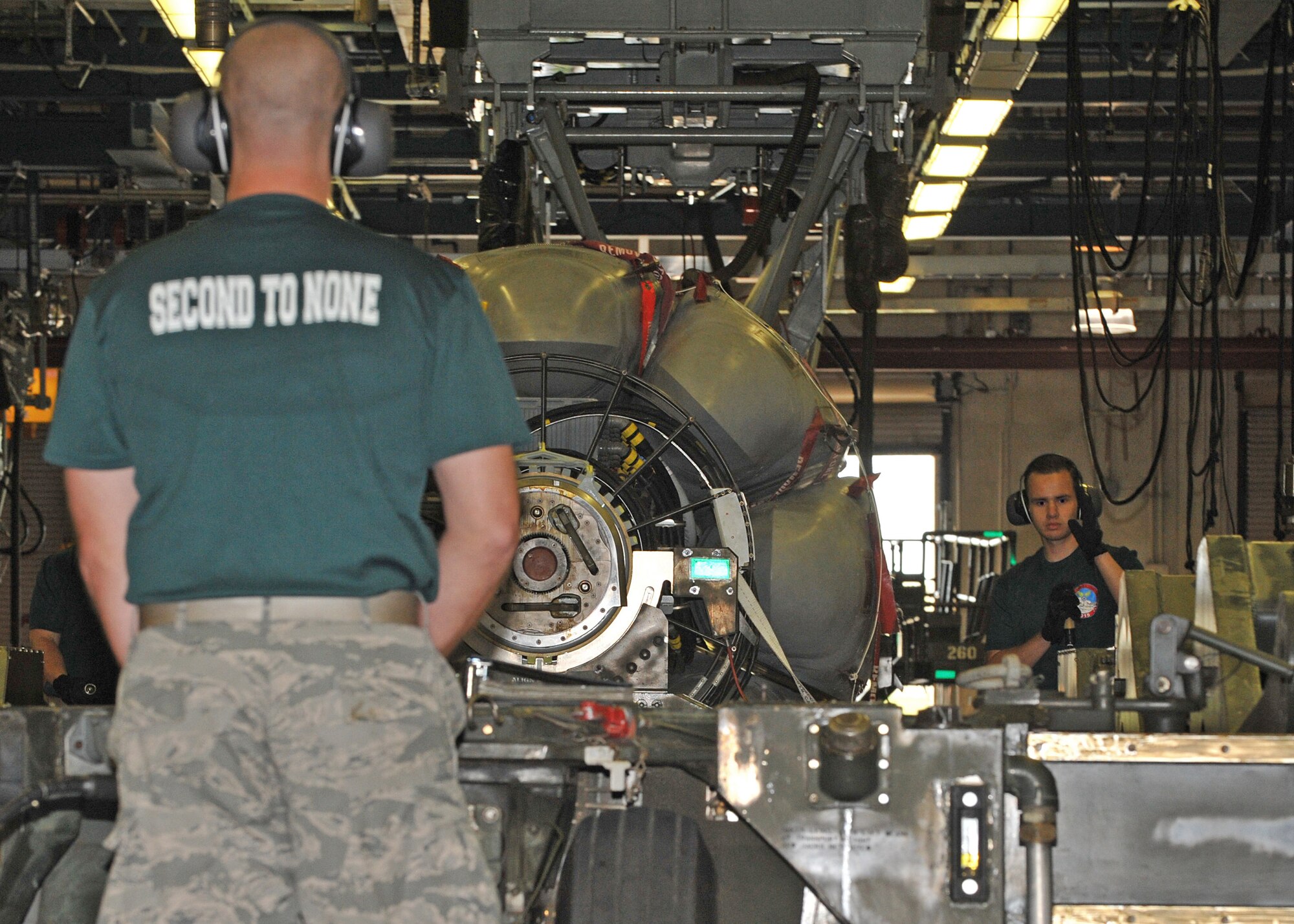 Senior Airman Javier Angulo, 2nd Munitions Squadron nuclear maintenance team member, motions to teammate Senior Airman Connor Johnson during the nuclear maintenance portion of the 2015 Global Strike Challenge at Barksdale Air Force Base, La., Sept. 1. The team transferred a B-52 Stratofortress’ common strategic rotary launcher from a trailer into a maintenance cradle. (U.S. Air Force photo/Senior Airman Joseph Raatz)