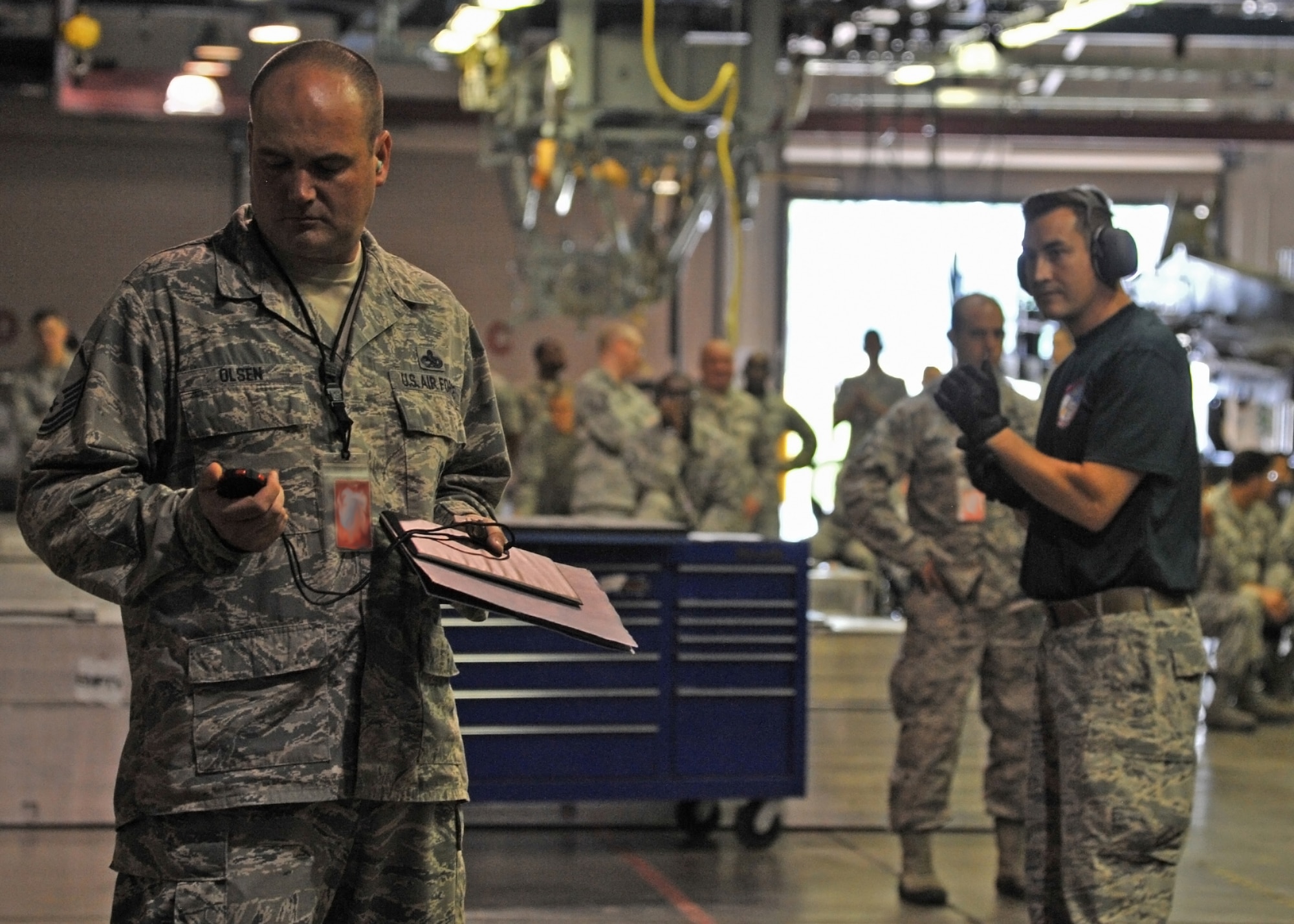 Master Sgt. Jeremy Olsen, 2015 Global Strike Challenge evaluator, consults a stopwatch to log the 2nd Munitions Squadron nuclear maintenance team’s final time during the nuclear maintenance competition at Barksdale Air Force Base, La., Sept. 1. More than 30 2nd MUNS personnel watched the team compete for the fastest time in Air Force Global Strike Command. (U.S. Air Force photo/Senior Airman Joseph Raatz)
