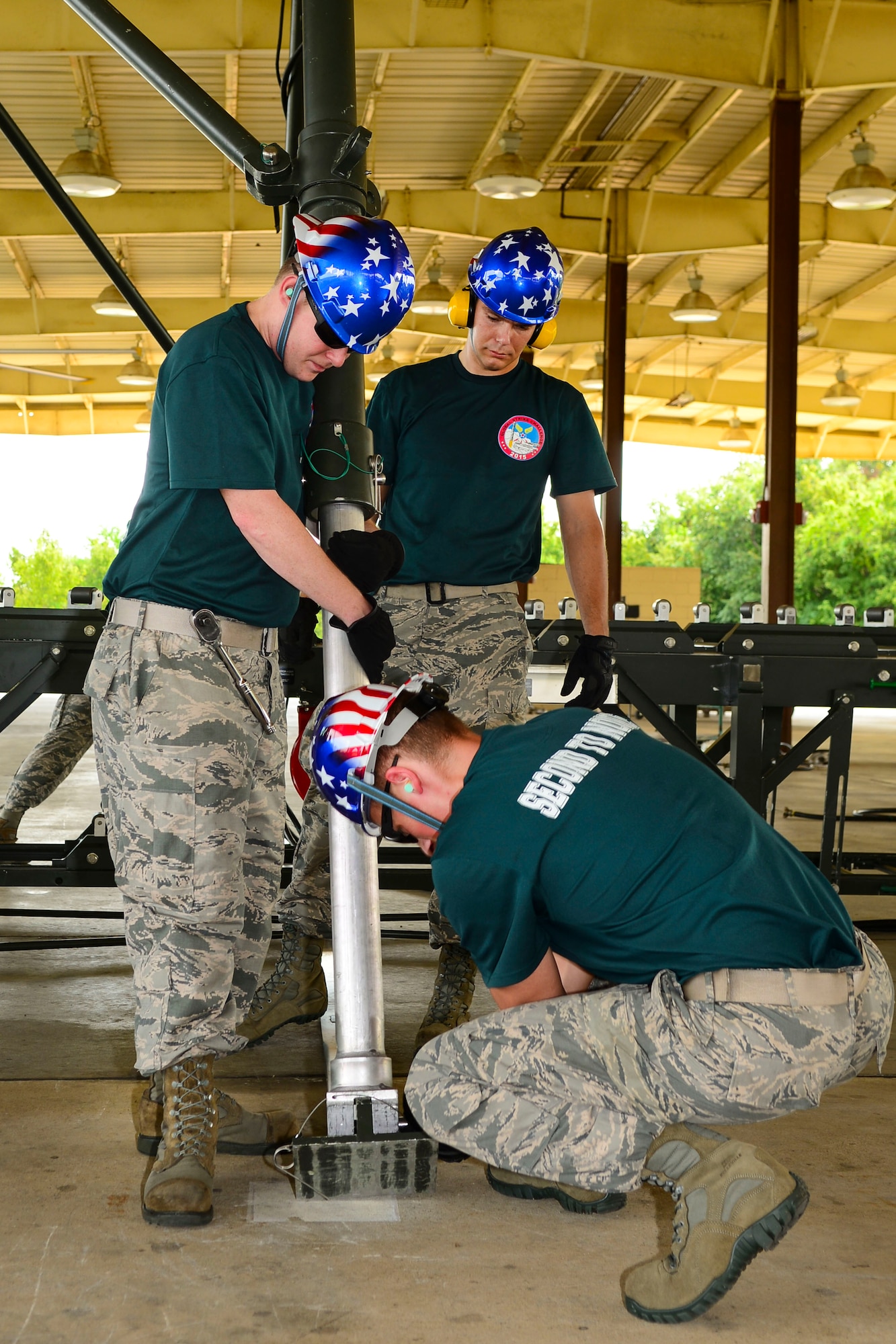 Airmen from the 2nd Munitions Squadron Conventional Bomb Build Team assemble a conveyor belt on which to assemble inert munitions on Barksdale Air Force Base, La., Aug. 31, 2015. The team represented the 2nd Bomb Wing during the conventional ammo competition during the 2015 Global Strike Challenge. (U.S. Air Force photo by Senior Airman Benjamin Raughton)