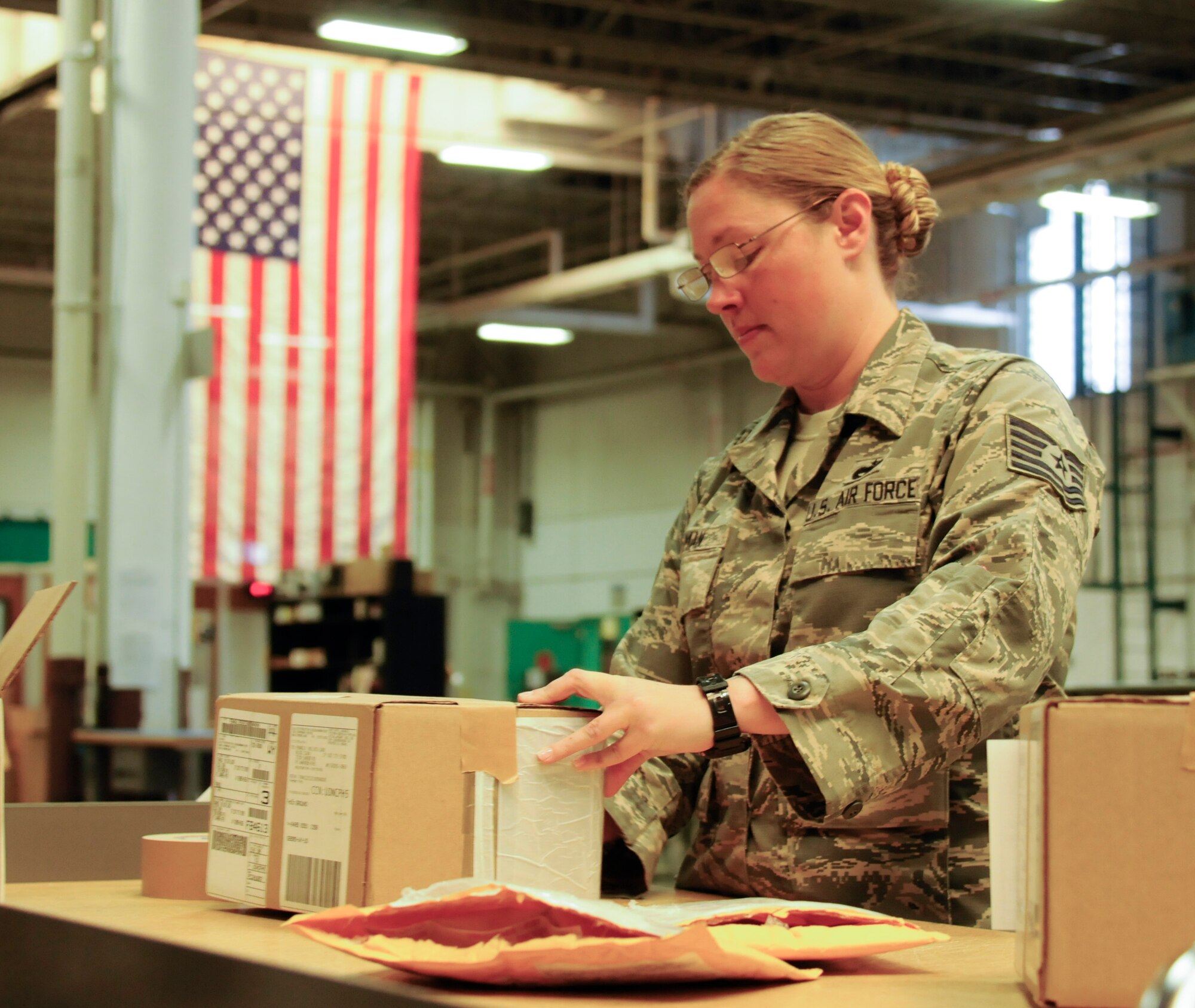 Tech. Sgt. Melissa Nyman, 90th Logistics Readiness Squadron non-commissioned-officer in charge of inbound cargo, labels a recently received item in the 90th LRS Warehouse on F.E. Warren Air Force Base, Wyo., Sept. 1, 2015. 90th LRS Inbound Cargo receives virtually every bit of material shipped to the base. (U.S. Air Force photo by Senior Airman Jason Wiese)
