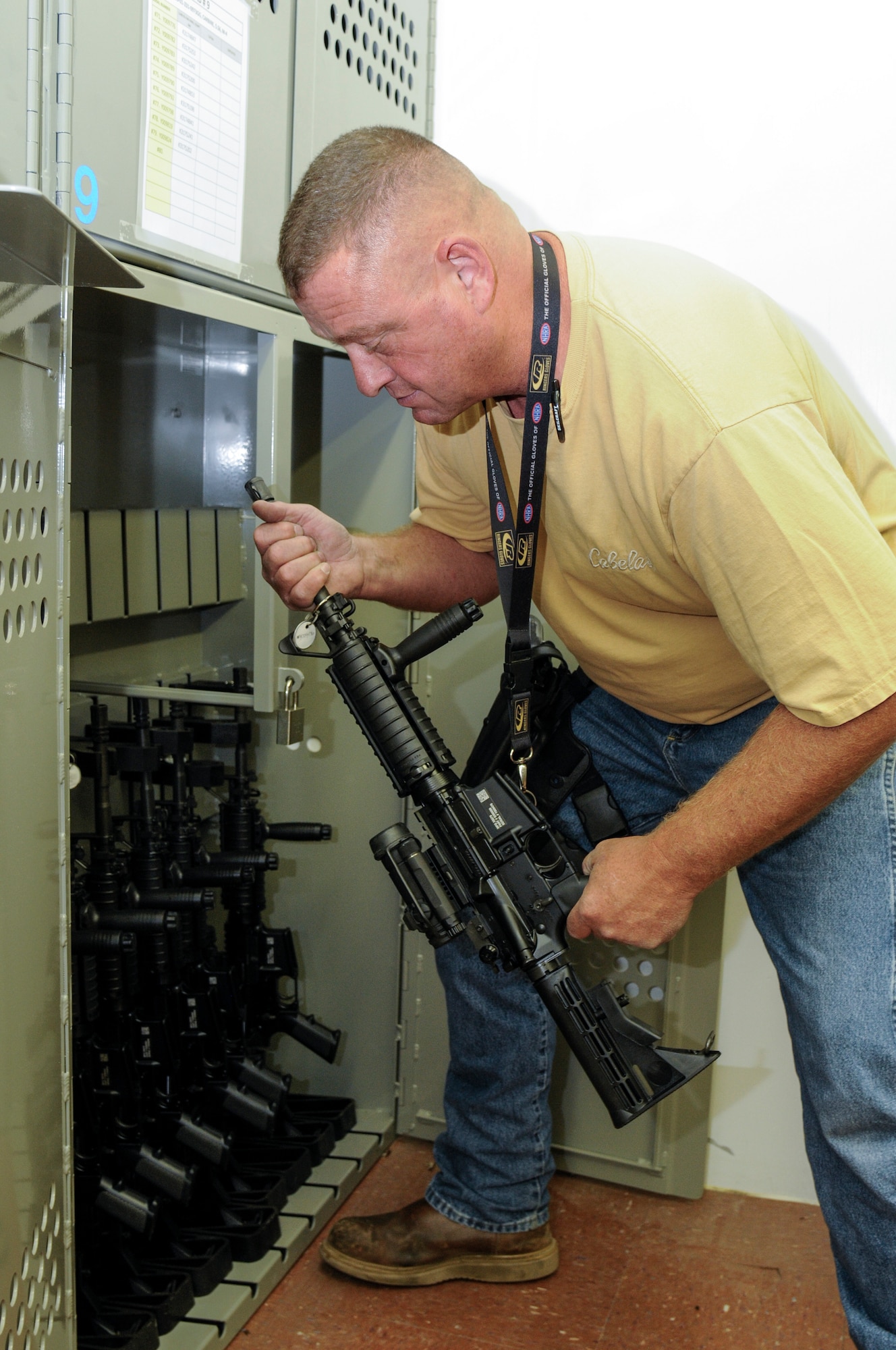 Brian Alexander, 90th Logistics Readiness Squadron materials handler, places an M-4 carbine in the armory of the 90th LRS Warehouse on F.E. Warren Air Force Base, Wyo., Sept. 2, 2015. Weapons not in use by the 90th Security Forces Group are stored by the 90th LRS. (U.S. Air Force photo by Senior Airman Jason Wiese)
