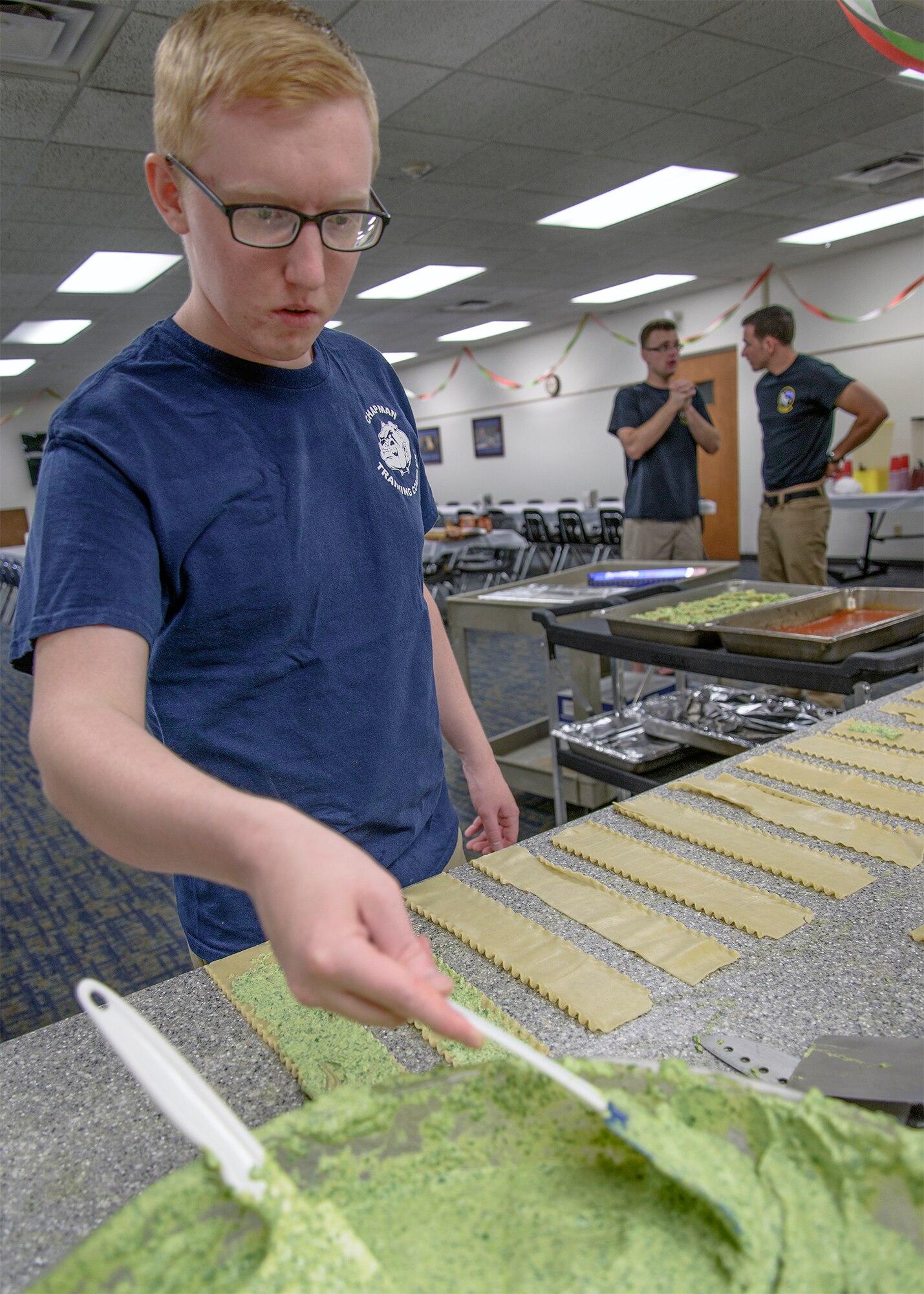 Airman 1st Class Max Schmidl fills spinach, ricotta pinwheels at Vance Air Force Base, Oklahoma, Aug. 31. The 71st Operations Support Squadron hosted the August Single International Gourmet Meal Opportunity, which is a monthly meal sponsored by the Base Chapel.  (U.S. Air Force photo / David Poe)