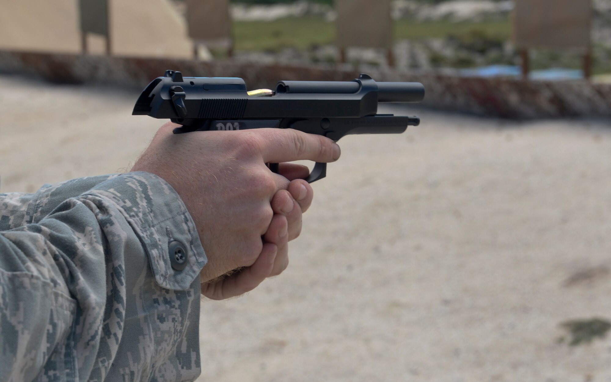 Staff Sgt. Travis Straw, 644th Combat Communications Squadron cyber system technician, reloads his M9 pistol before firing downrange Sept. 1, 2015 at the Combat Arms Training and Maintenance range on Andersen Air Force Base, Guam. The CATM mission is to ensure all weapons utilized by 36th Wing members are functional, maintained and ready when the Airmen are called to duty. (U.S. Air Force photo by Staff Sgt. Robert Hicks/Released)