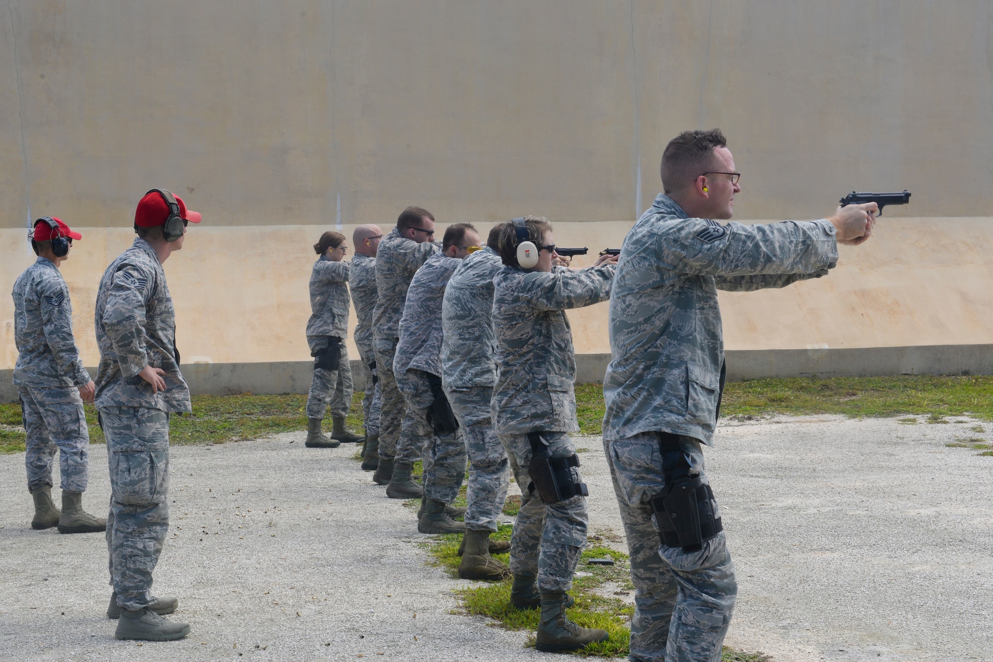 36th Sercurity Forces Squadron Combat Arms Training and Maintenance instructors supervise an M9 pistol qualification course at Andersen Air Force Base, Guam, Sept. 1, 2015. The CATM mission is to ensure all weapons utilized by 36th Wing members are functional, maintained and ready when the Airmen are called to duty. (U.S. Air Force photo by Staff Sgt. Robert Hicks/Released)