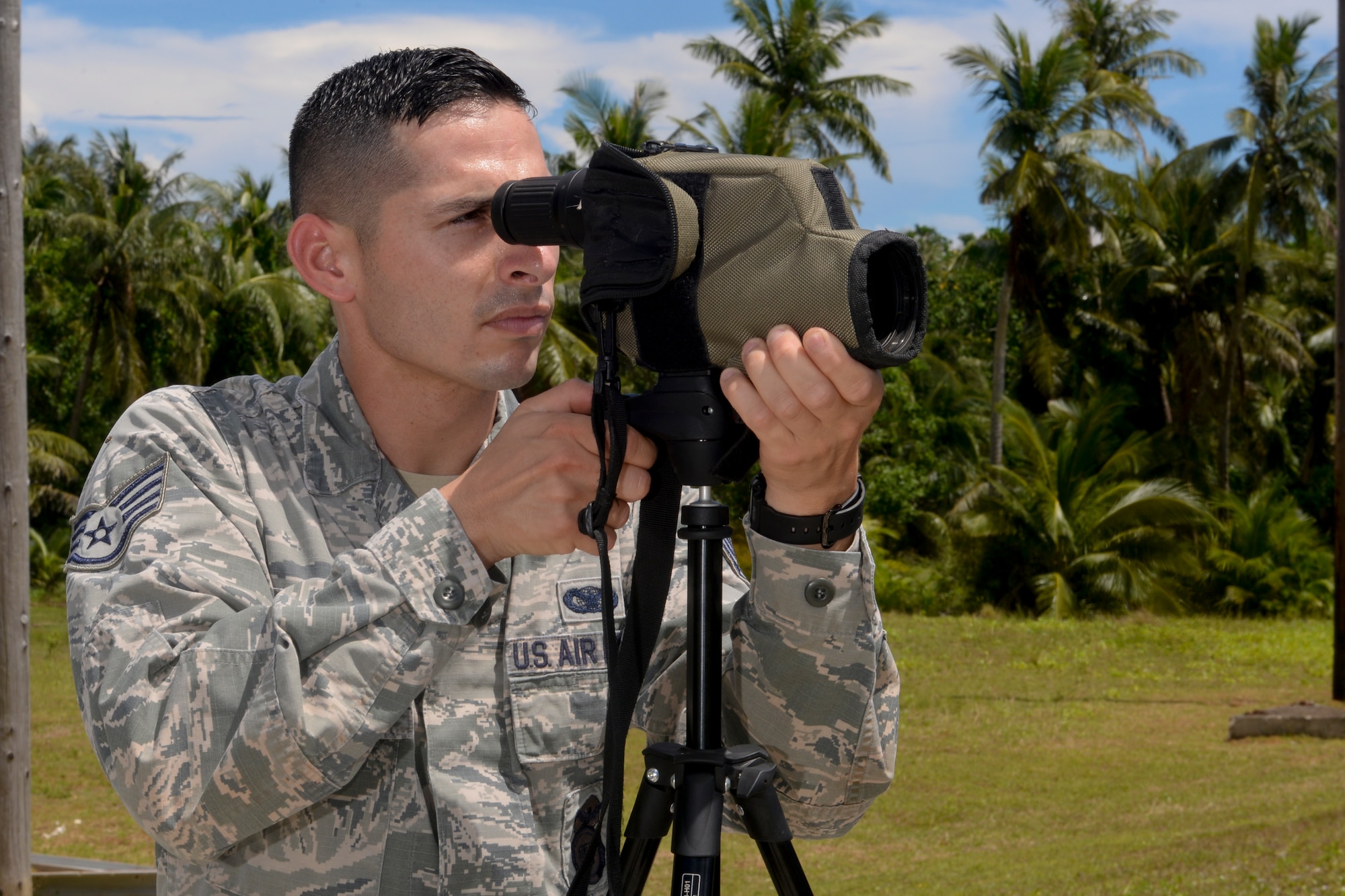 Staff Sgt. Melquiades Maciel, 36th Security Forces Squadron Combat Arms Training and Maintenance instructor, looks down the sights of a plotting scope while his wingman fires an M24 sniper rifle Sept. 1, 2015, at Andersen Air Force Base, Guam. The plotting scope allows one to see downrange to help the shooter make necessary adjustments to hit the target. (U.S. Air Force photo by Staff Sgt. Robert Hicks/Released)