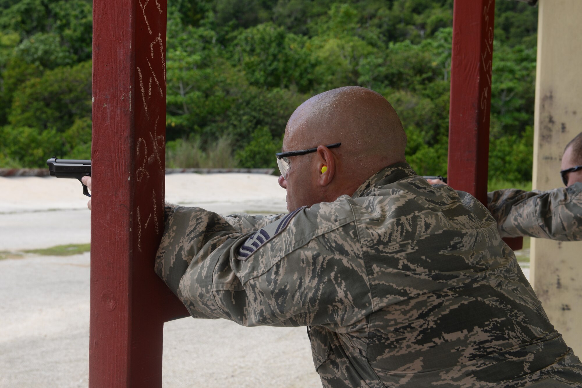 Senior Master Sgt. Vincent Blanton, 644th Combat Communications Squadron Radio Frequency Transmissions Flight chief, fires a round downrange Sept. 1, 2015, at the Combat Arms Training and Maintenance range on Andersen Air Force Base, Guam. The CATM mission is to ensure all weapons utilized by 36th Wing members are functional, maintained and ready when the Airmen are called to duty. (U.S. Air Force photo by Staff Sgt. Robert Hicks/Released)