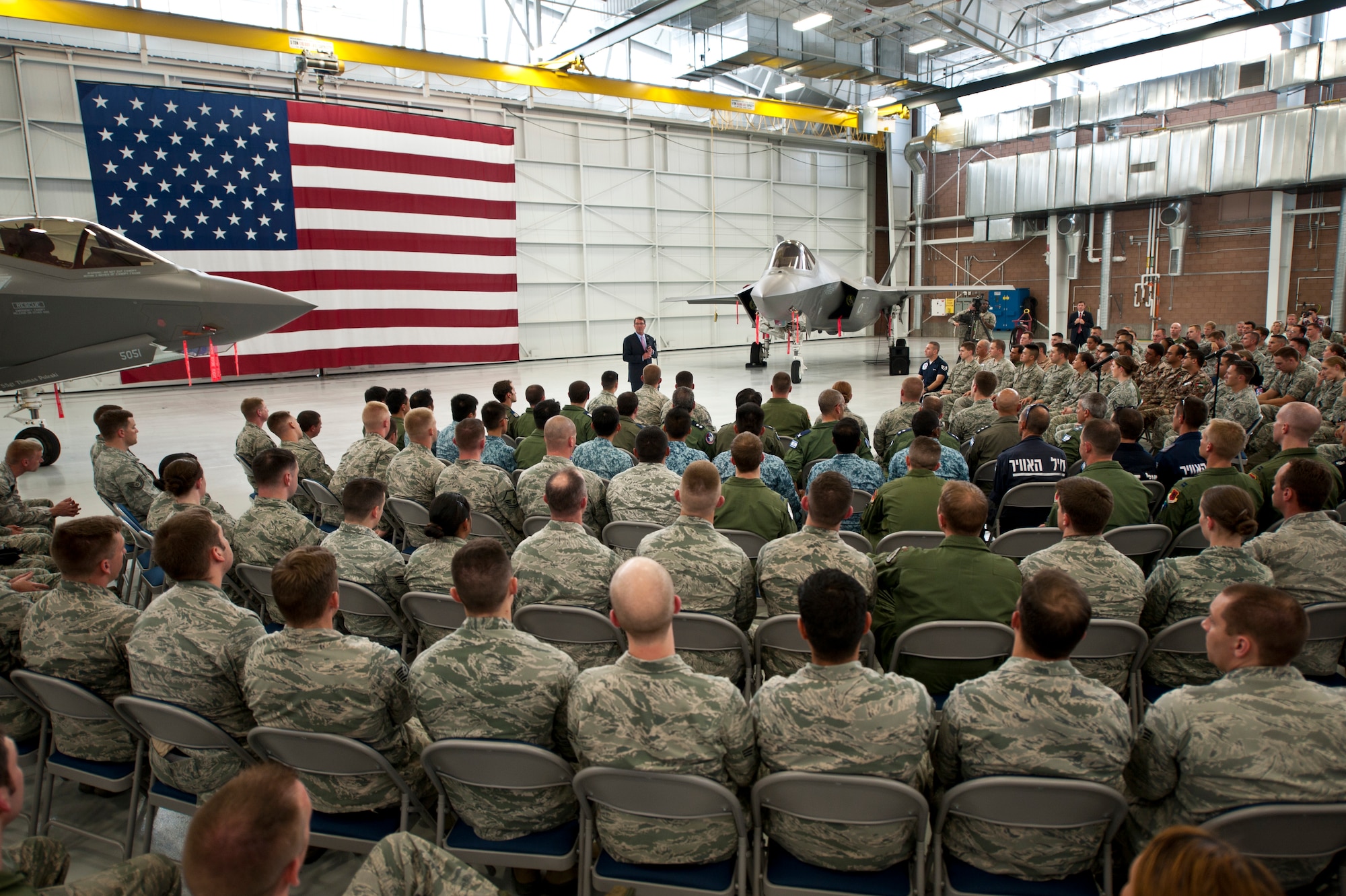Defense Secretary (Dr.) Ash Carter addresses Nellis Airmen and Coalition partners during an all call inside the Lightning Aircraft Maintenance Unit hangar at Nellis Air Force Base, Nev., Aug. 26, 2015. During the Secretary’s visit to Nellis he observed Red Flag 15-4 and spoke to Airmen and Coalition partners. During the all call, Carter took questions from service members and addressed issues relating to budgets, force retention, morale, and operational priorities. Carter, the nation’s 25th Defense Secretary, was sworn into the position earlier this year on February 17. (U.S. Air Force photo by Senior Airman Joshua Kleinholz)