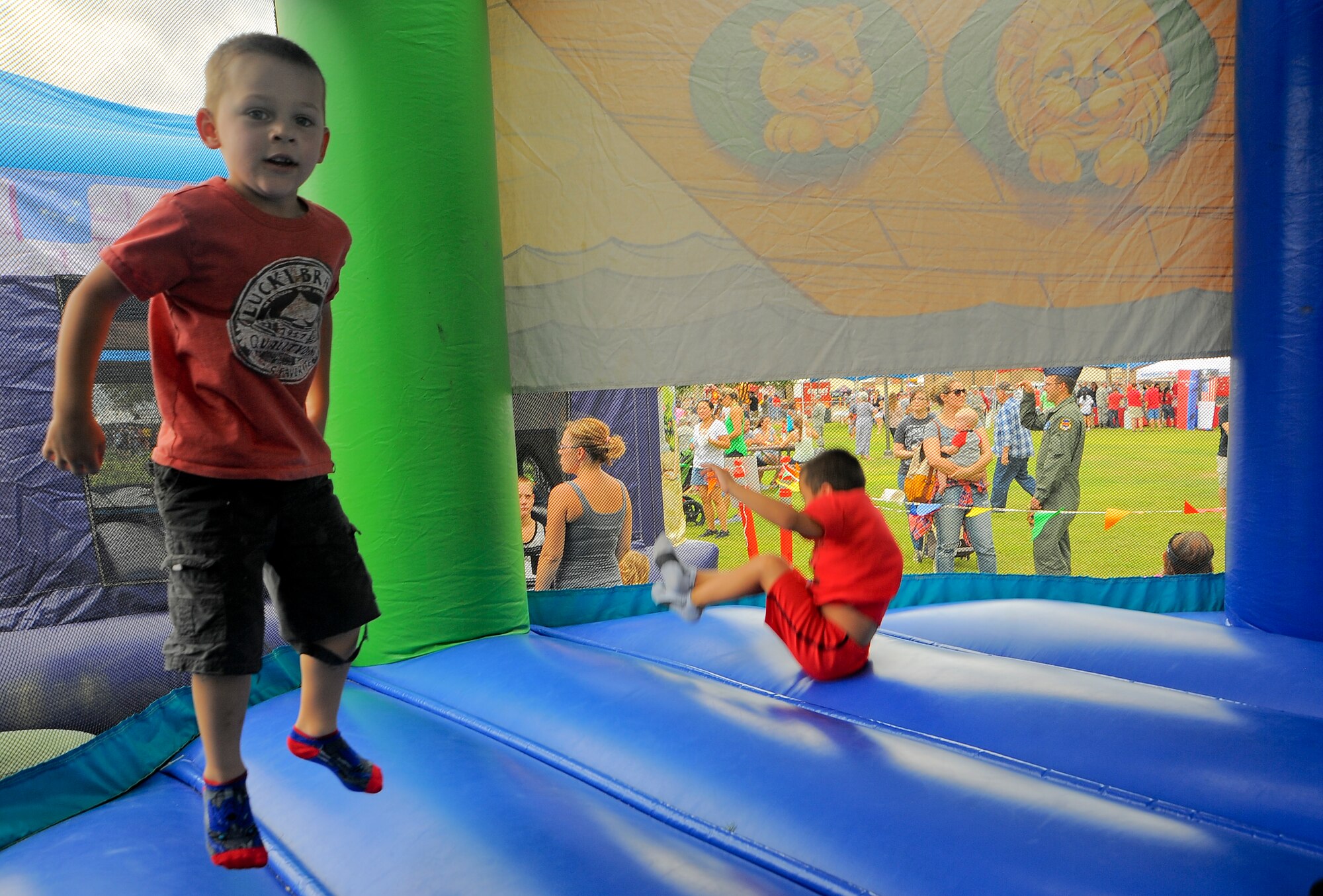 Lucas Foote, son of U.S Air Force Senior Airman Jonathan Foote, 355th Maintenance Group, jumps in a bounce castle at the “Welcome Home” Barbecue at Davis-Monthan Air Force Base, Ariz., Sept. 3, 2015. The barbecue was dedicated by the Tucson community to D-M Airmen and their families.  (U.S. Air Force photo by Airman 1st Class Mya M. Crosby/Released) 