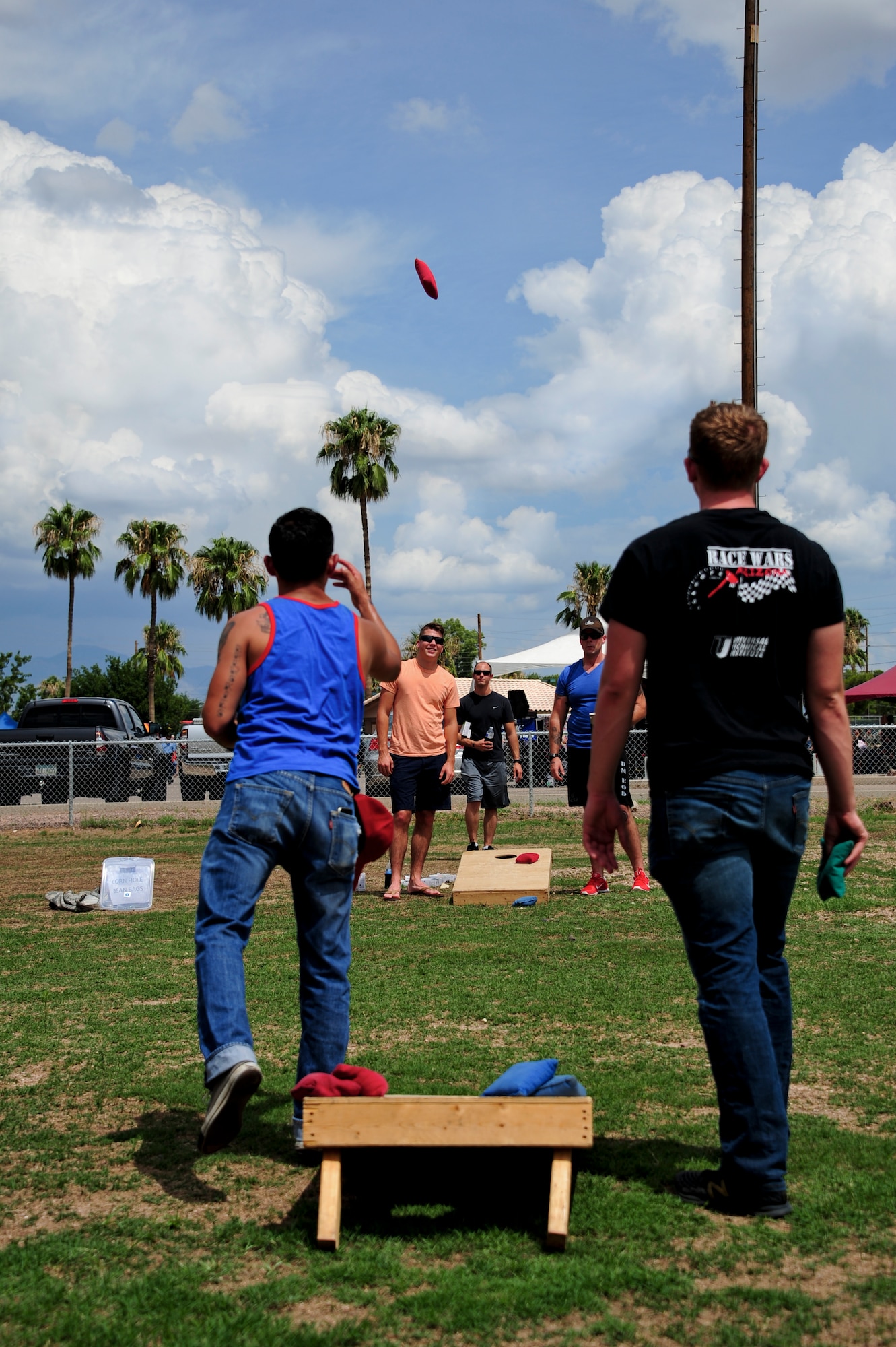 U.S. Air Force Desert Lightning Team Airmen play cornhole at Bama Park during the “Welcome Home” barbecue at Davis-Monthan Air Force Base, Ariz., Sept. 3, 2015. The event was hosted by the Tucson community to show its appreciation for D-M’s servicemen and servicewomen who returned from the base’s largest deployment since World War II. (U.S. Air Force photo by Airman 1st Class Chris Drzazgowski/Released)