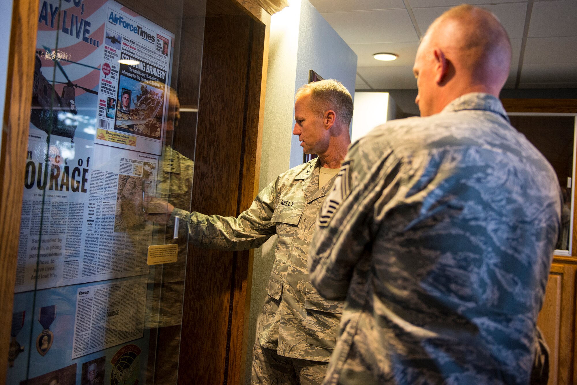 U.S. Air Force Maj. Gen. Mark Kelly, Ninth Air Force commander, and Chief Master Sgt. Frank Batten, Ninth AF command chief, view a remembrance case of fallen pararescuemen Senior Airman Jason Cunningham at the Airman Leadership School Aug. 31, 2015, at Moody Air Force Base, Ga. Kelly was providing overwatch in an F-15E Strike Eagle when Cunningham’s helicopter crashed in 2002. Moody dedicated its ALS to Cunningham, who was assigned to the 38th Rescue Squadron when he was killed in action during Operation Anaconda in Afghanistan. (U.S. Air Force photo by Airman 1st Class Ceaira Tinsley/Released)