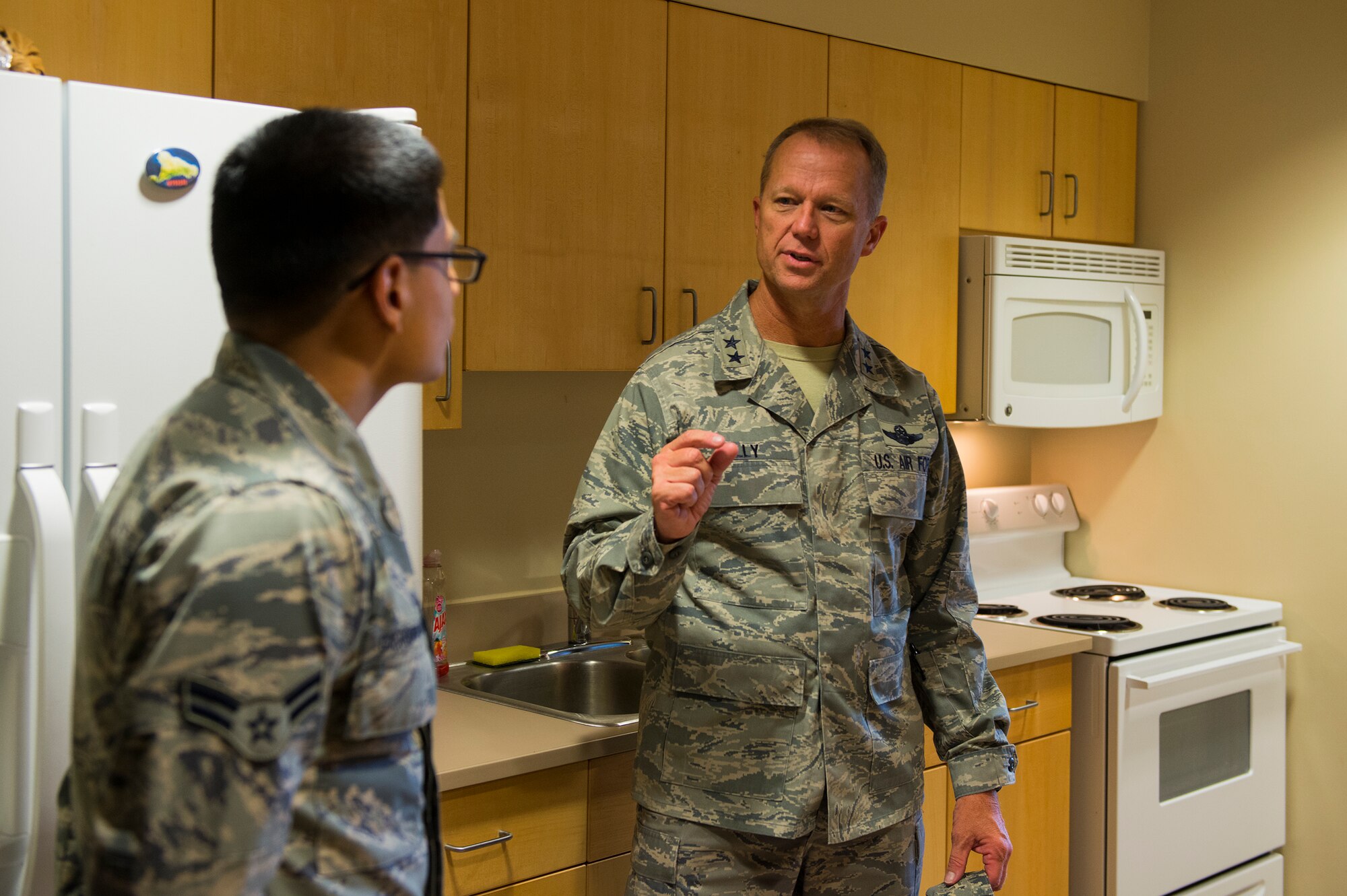 U.S. Air Force Maj. Gen. Mark Kelly, Ninth Air Force commander, talks to Airman 1st Class David Guerrero-Suarez, 23rd Security Forces Squadron entry controller, Aug. 31, 2015, at Moody Air Force Base, Ga. Guerrero-Suarez, 23rd SFS Dorm of the Quarter winner, was selected to give Kelly a tour of the dorm facility and his room. The general also toured various organizations around base. (U.S. Air Force photo by Airman 1st Class Ceaira Tinsley/Released)