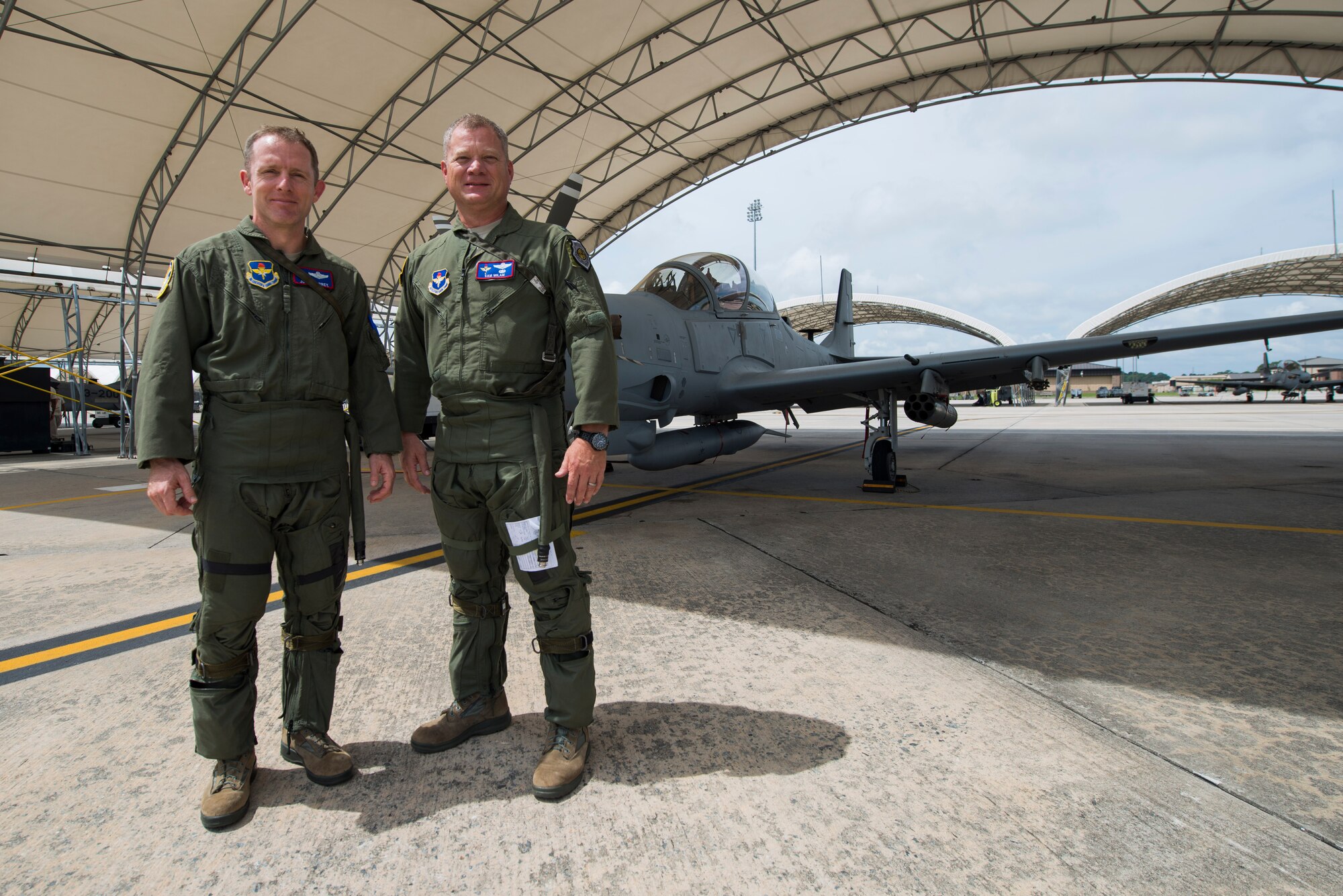 U.S. Air Force Brig. Gen. John Cherrey (left), Air Education and Training Command director of intelligence, operations and nuclear integration, and Col. Samuel Milam,  AETC inspector general, pose for a photo after an A-29 Super Tucano flight Sep. 1, 2015, at Moody Air Force Base, Ga. The 81st Fighter Squadron is a unique organization comprised of Air Advisor pilots, Air Advisor maintainers and support personnel who provide CONUS and OCONUS based training for the Afghan air force. (U.S. Air Force photo by Airman 1st Class Dillian Bamman/Released)