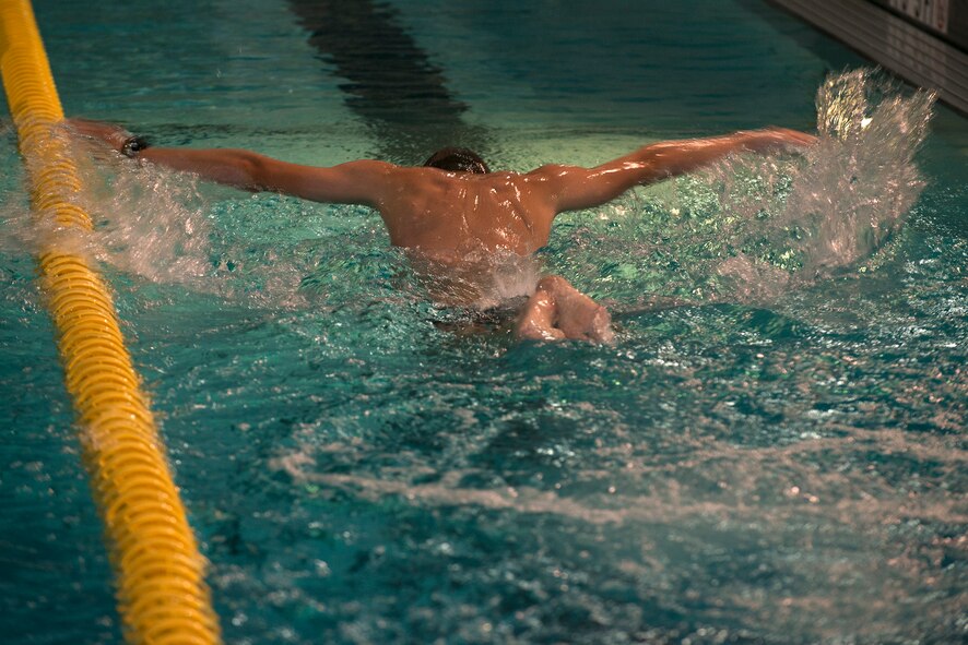 Erik Kacprzyk, 23d Force Support Squadron lifeguard, performs a butterfly stroke while swimming in the indoor pool Aug. 31, 2015, at Moody Air Force Base, Ga. The indoor pool is open to all base personnel for lap swim, scheduled swim lessons or unit training sessions. (U.S. Air Force photo by Airman 1st Class Kathleen D. Bryant/Released)