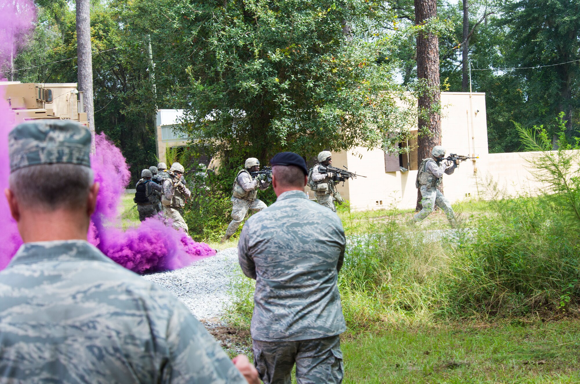 U.S. Air Force Maj. Gen. Mark Kelly, Ninth Air Force commander, (left), watches as the 820th Base Defense Group performs a demonstration at the Military Operations in Urban Terrain complex during his visit Sept. 1, 2015, at Moody Air Force Base, Ga. Airmen from the 820th BDG showcased their unique capabilities to provide fully integrated force protection. (U.S. Air Force photo by Airman 1st Class Ceaira Tinsley/Released)
