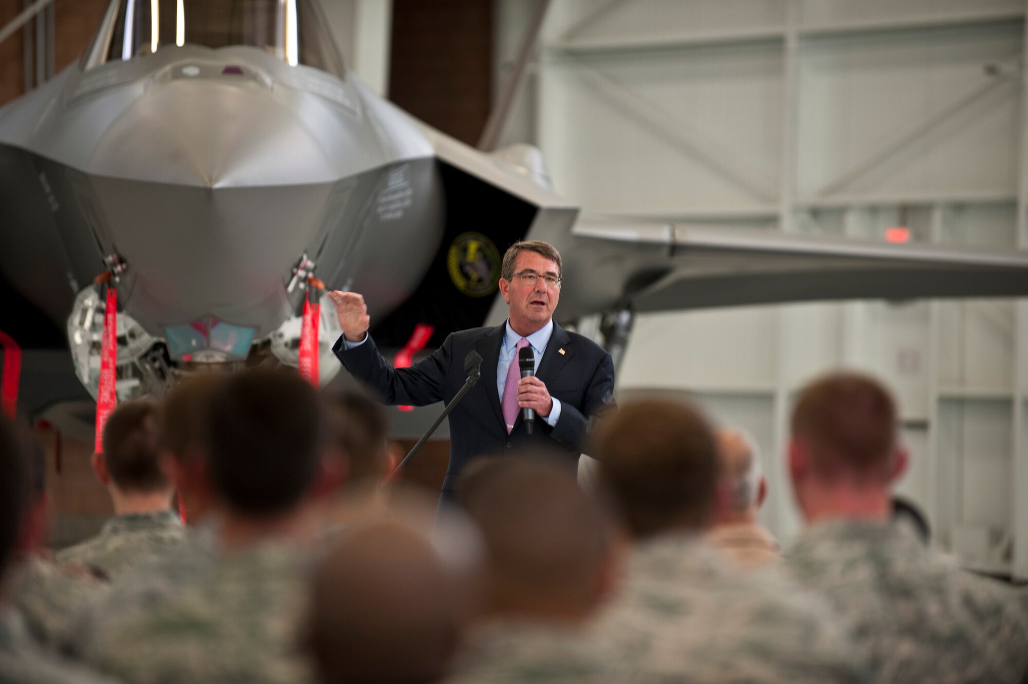 Defense Secretary (Dr.) Ash Carter addresses Nellis Airmen and Coalition partners during an all call inside the Lightning Aircraft Maintenance Unit hangar at Nellis Air Force Base, Nev., Aug. 26, 2015. During the Secretary’s visit to Nellis he observed Red Flag 15-4 and spoke to Airmen and Coalition partners. During the all call, Carter took questions from service members and addressed issues relating to budgets, force retention, morale, and operational priorities. Carter, the nation’s 25th Defense Secretary, was sworn into the position earlier this year on February 17. (U.S. Air Force photo by Senior Airman Joshua Kleinholz)