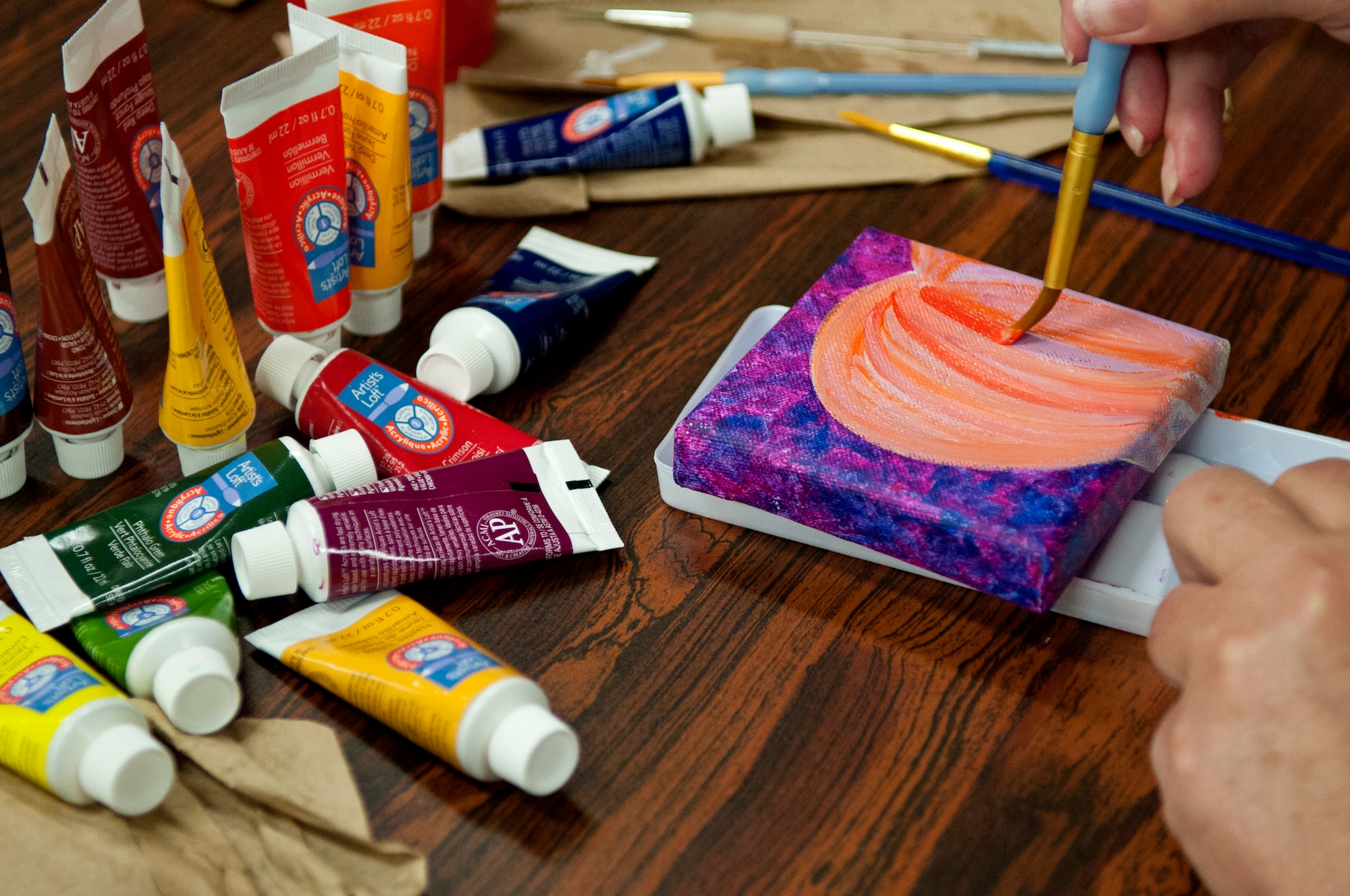 Tammy Amon, 4th Force Support Squadron information specialist, paints a pumpkin, Aug. 30, 2015, at Seymour Johnson Air Force Base, North Carolina. The Painting Club designs pictures for the Arts Council of Wayne County to contribute to two art alleys in the Goldsboro community. (U.S. Air Force photo/ Airman 1st Class Shawna L. Keyes)