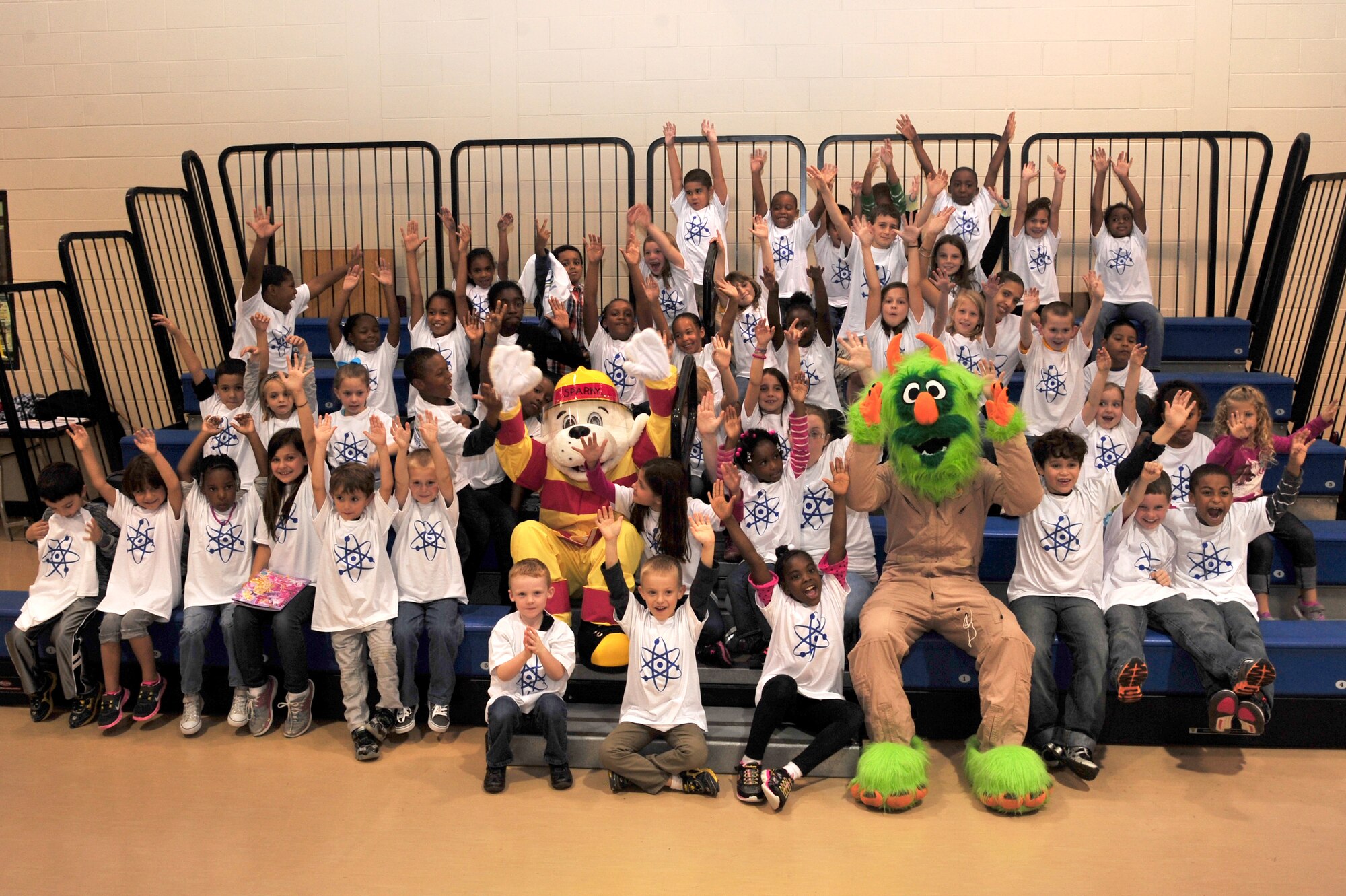 Children from the youth center participate in an Energy Action Month and Fire Prevention Week event with Sparky, 4th Civil Engineer Squadron fire prevention mascot, and Airman e-BEAST, 4th CES energy awareness mascot, Oct. 16, 2013, at Seymour Johnson Air Force Base, North Carolina,. The mascots visited the children to talk about energy conservation and fire safety. (U.S. Air Force photo/Senior Airman Mariah Tolbert)