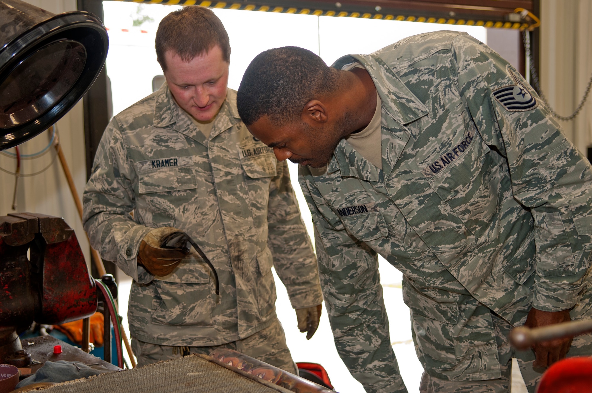 Senior Airman Matthew Kramer (left), 4th Civil Engineer Squadron heating, ventilation, and air conditioning technician, has Tech. Sgt. Kennieth Anderson, 4th CES HVAC NCO in charge, quality check his work, Sept. 2, 2015, at Seymour Johnson Air Force Base, North Carolina. More than 1,500 hours have been spent on individual buildings, in mechanical rooms, and with facility managers to improve maintenance practices, corrected control settings for chillers, and identification of faulty control and actuators that led to thousands of dollars in savings. (U.S. Air Force photo/Airman 1st Class Shawna L. Keyes)      