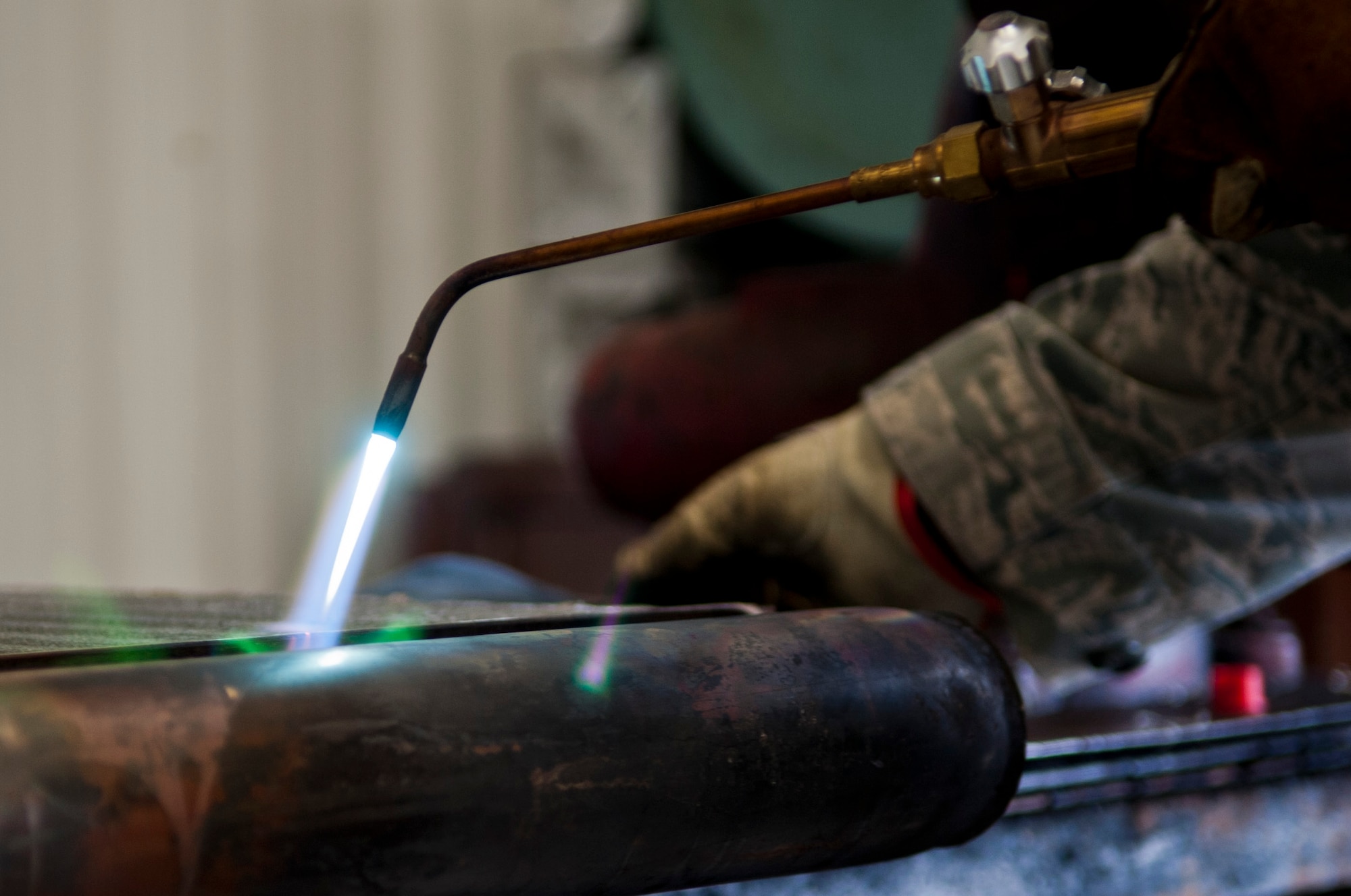Senior Airman Matthew Kramer, 4th Civil Engineer Squadron heating, ventilation, and air conditioning technician, solders a piece of HVAC equipment, Sept. 2, 2015, at Seymour Johnson Air Force Base, North Carolina. During the last two years, annual maintenance and tune-ups have improved indoor air quality, building HVAC system controls, and increased the life of the HVAC system as a whole, which was one of the factors in the squadron being awarded the 2015 Federal Energy & Water Management award. (U.S. Air Force photo/Airman 1st Class Shawna L. Keyes) 