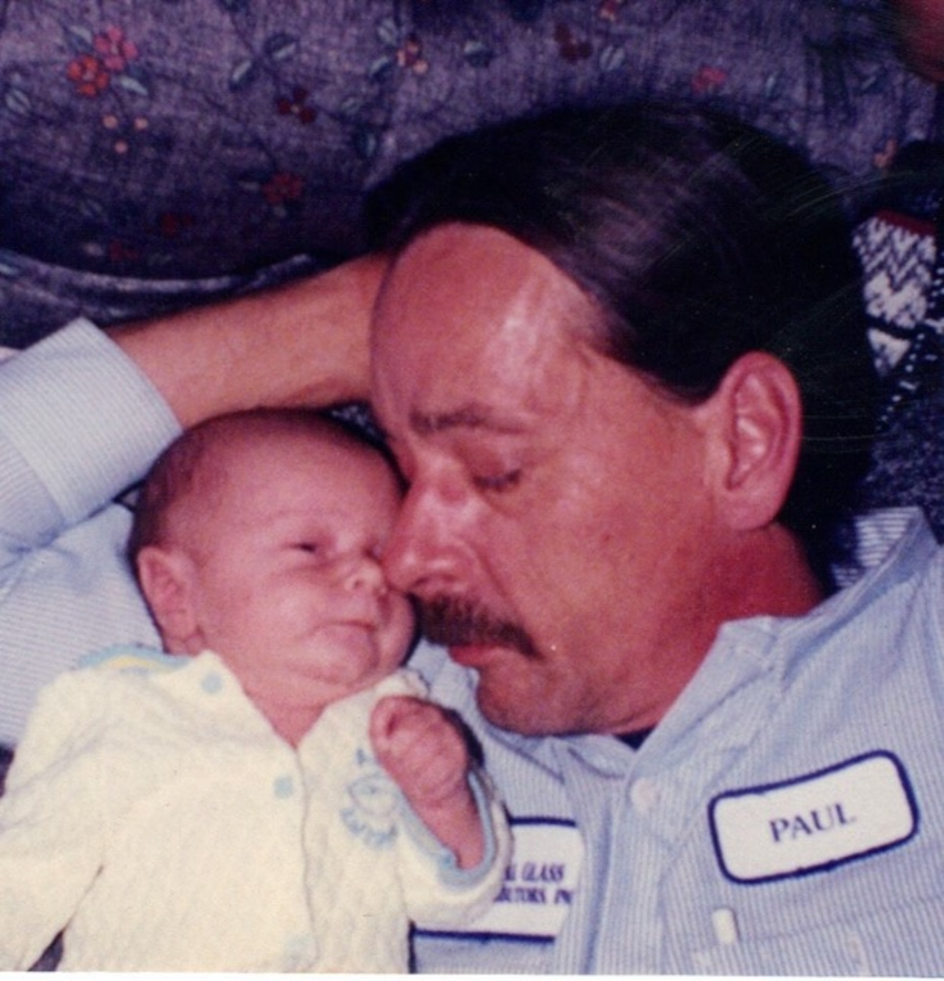 U.S. Air Force Airman 1st Class Daniel Meyer, 55th Aircraft Maintenance Squadron, lays in the arms of his father, Paul Meyer. Meyer saw his father as his mentor, disciplinarian, friend, counselor, and hero. (Courtesy photo)