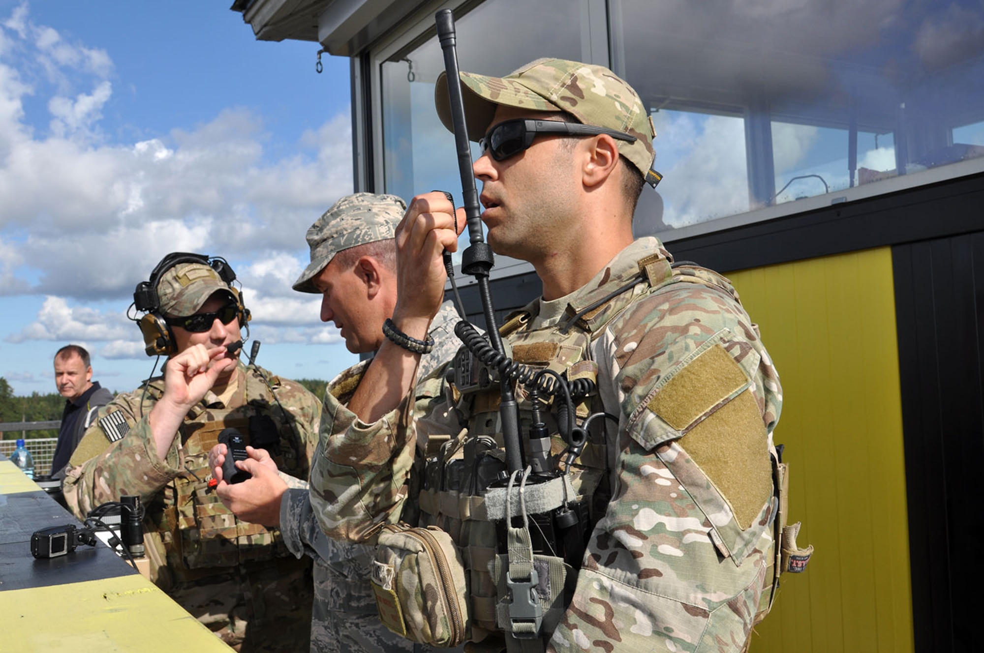 Tech. Sgt. Ben Lake and Master Sgt. Larry Mansel, both Air National Guard Joint Terminal Attack Controllers from the 146th Air Support Operations Squadron out of Oklahoma City, Okla., show Command Chief Master Sgt. James Nudd from the 442d Fighter Wing how to use equipment during a training exercise at Tapa Range in Estonia Aug. 31.  The U.S. Air Force is training with the Estonian AF on air to ground maneuvers using close air support from A-10 Thunderbolt IIs with the 303d Fighter Squadron from Whiteman Air Force Base, Mo. This training is part of Operation Atlantic Resolve where the U.S. is training with European Allies to face potential future challenges. (U.S. Air Force photo by Capt. Denise Haeussler)