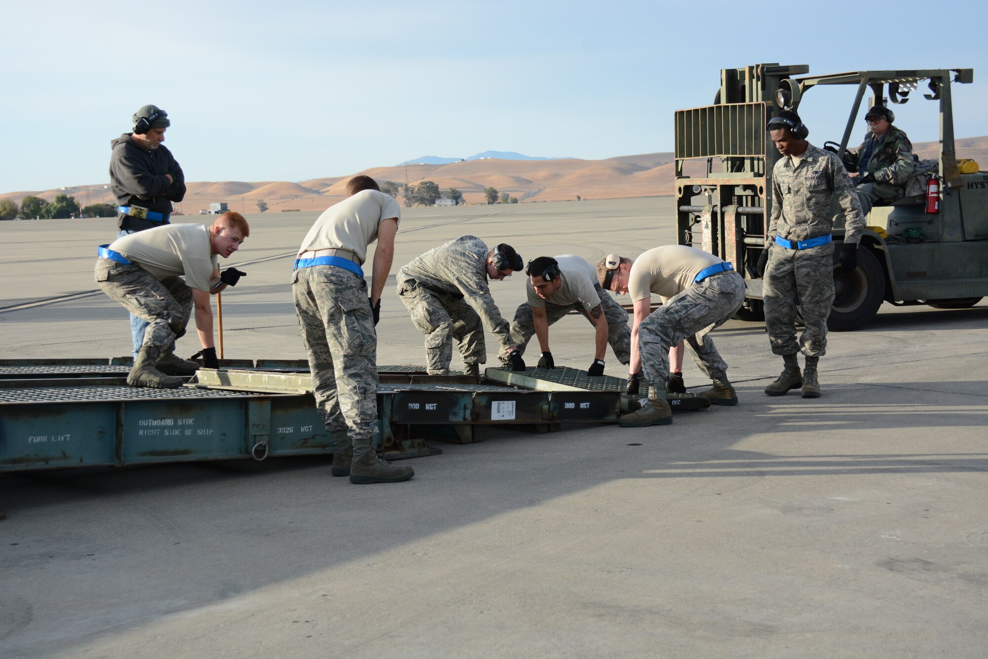Airmen from the 60th Aerial Port Squadron construct a ramp Aug. 28 at Travis Air Force Base, Calif. The C-5 portable loading ramp used, also known as the minute-man ramp, is one of only two remaining in the world. (U.S. Air Force photo by Airman 1st Class Amber Carter)
