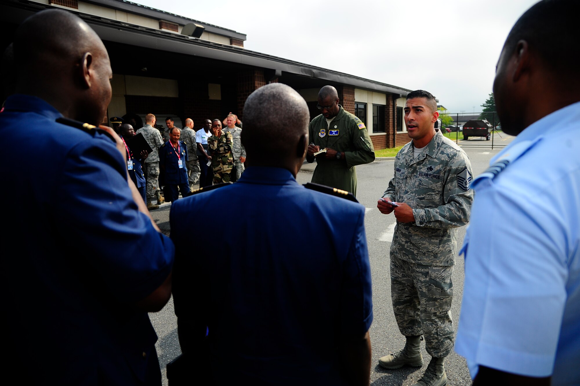 Master Sgt. Carlos Damian, 305th Aircraft Maintenance Squadron, briefs visiting African military personnel at Joint Base McGuire-Dix-Lakehurst during the African Partnership Flight hosted by the 621st Contingency Response Wing Sept. 2, 2015. During the weeklong engagement, U.S. Airmen from JB MDL focused on sharing ideas and experiences with African counterparts in the realm of logistics management and aircraft maintenance in order to develop mutual understanding and strengthen relationships between participants. (U.S. Air Force photo by 1st Lt. Jake Bailey)