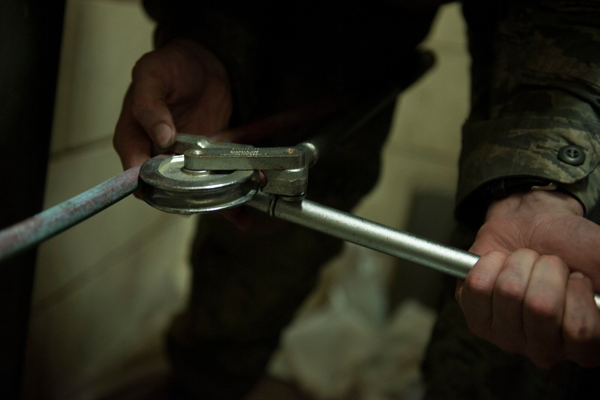Staff Sgt. Matthew Browning, 8th Civil Engineer Squadron Heating, Ventilation, Air Conditioning and Refrigeration shop craftsman, measures out copper to bend and form to the condenser, at Kunsan Air Base, Republic of Korea, September 4, 2015. HVAC-R Airmen are responsible for installing, and repairing heating, ventilation, air conditioning and refrigeration units. (U.S. Air Force photo by SrA Dustin King/Released)