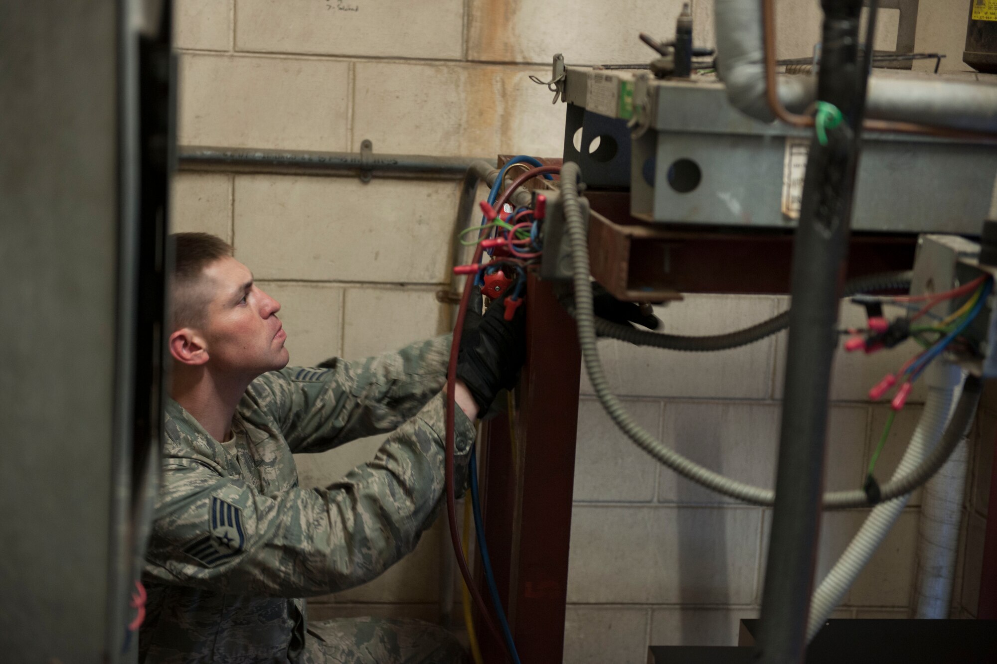 Staff Sgt. Matthew Browning, 8th Civil Engineer Squadron Heating, Ventilation, Air Conditioning and Refrigeration shop craftsman, sets up the condenser for the Dining Facility, at Kunsan Air Base, Republic of Korea, September 4, 2015. HVAC-R Airmen are responsible for installing, and repairing heating, ventilation, air conditioning and refrigeration units. (U.S. Air Force photo by SrA Dustin King/Released)