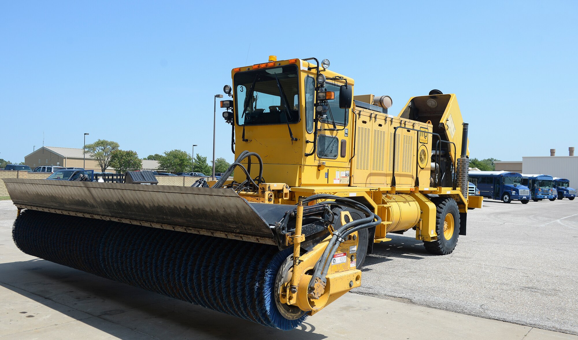 A snow broom vehicle sits in the parking lot of the 22nd Logistics Readiness Squadron vehicle maintenance shop, Sept. 2, 2015, at McConnell Air Force Base, Kan. Each vehicle must be cleaned, serviced, and inspected before being leaving the lot. (U.S. Air Force photo by Senior Airman Colby L. Hardin)