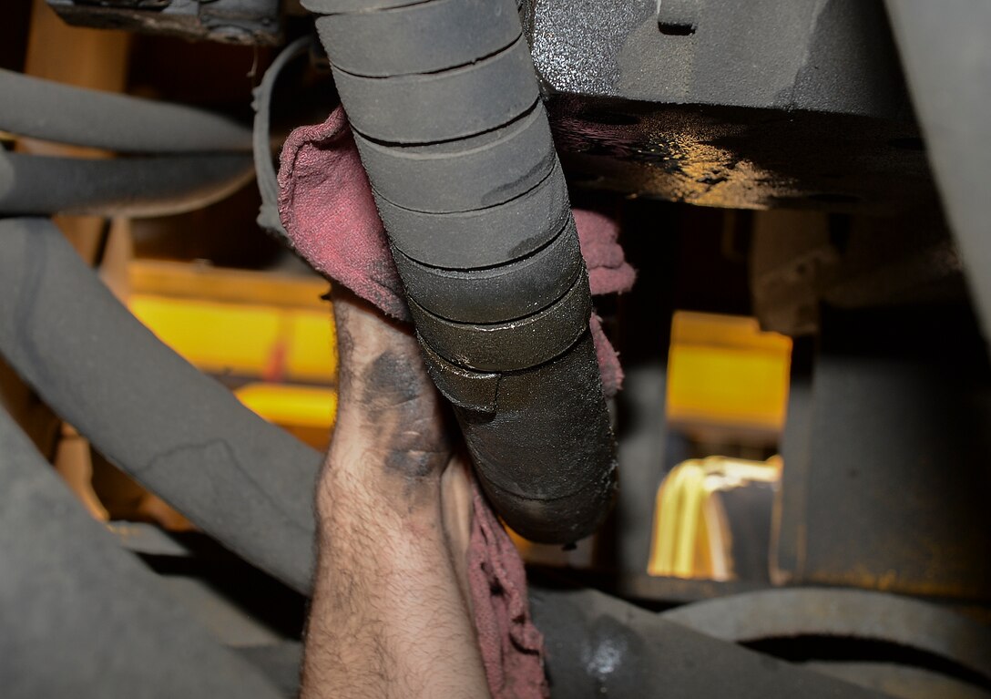 Senior Airman Ian Boutwell, 22nd Logistics Readiness Squadron vehicle maintenance journeyman, cleans off leftover oil residue from a snow broom vehicle, Sept. 2, 2015, at McConnell Air Force Base, Kan. Each vehicle must be cleaned before leaving the shop at any time. (U.S. Air Force photo by Senior Airman Colby L. Hardin)