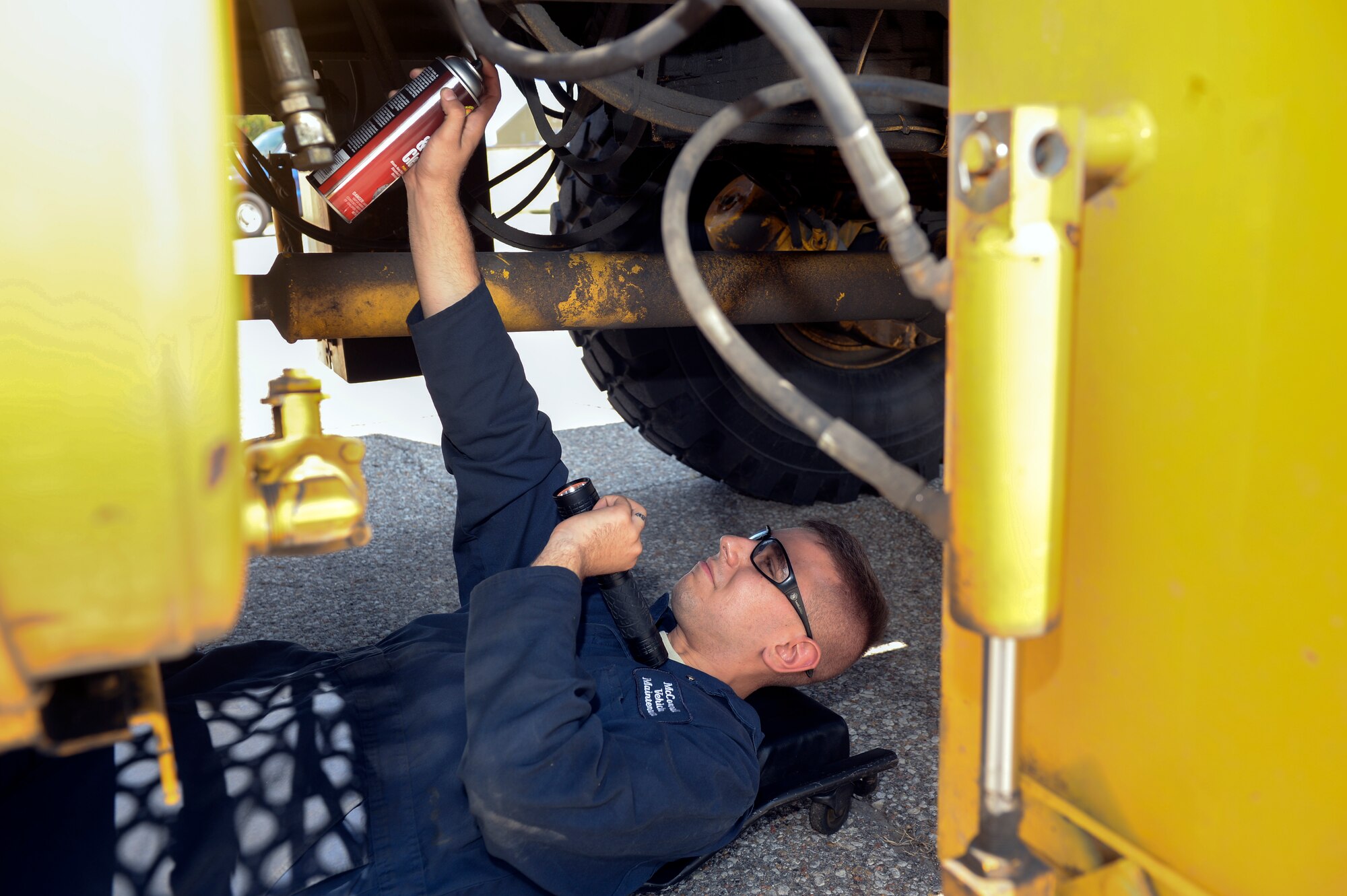 Senior Airman Ian Boutwell, 22nd Logistics Readiness Squadron vehicle maintenance journeyman, cleans the pipes under a snow broom vehicle, Sept. 2, 2015, at McConnell Air Force Base, Kan. Boutwell must clean each part of the snow broom as a part of the summer rebuild, in which each vehicle get serviced and prepared for the upcoming cold seasons. (U.S. Air Force photo by Senior Airman Colby L. Hardin)